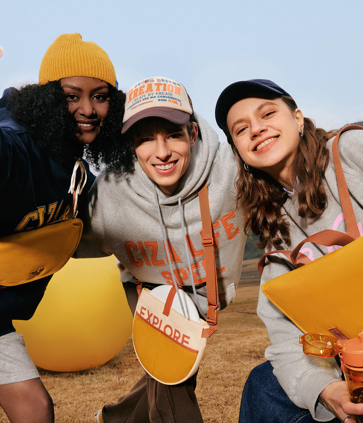 Three friends outdoors with stylish crossbody bags, hoodies, and caps, perfect for casual adventures and everyday use.