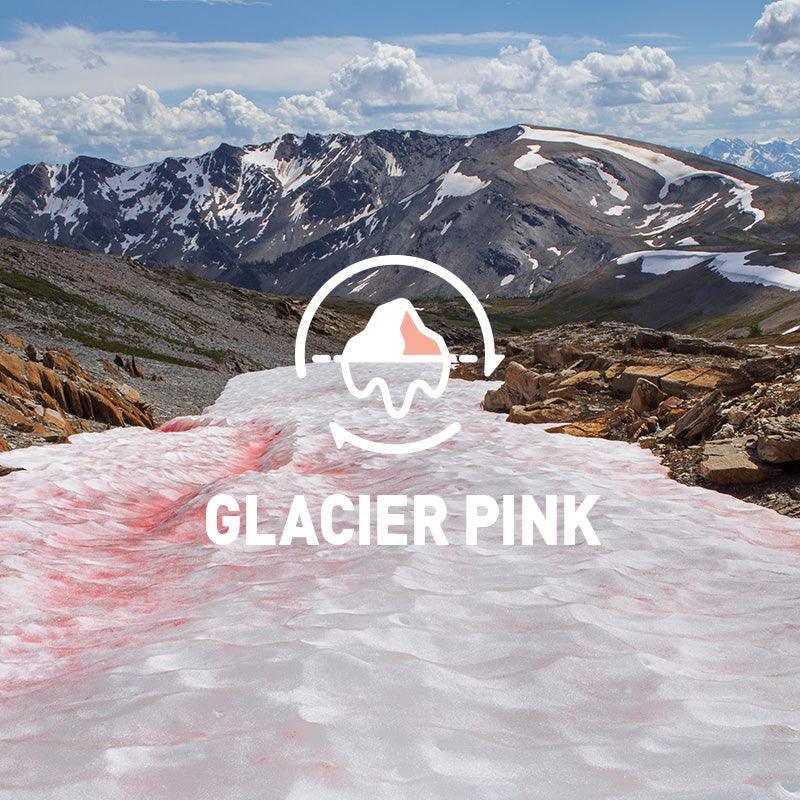 Glacier pink snow under blue sky with mountain peaks, showcasing natural alpine scenery