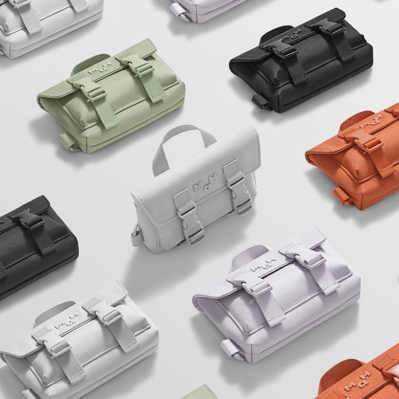 Compact mini crossbody bags in multiple colors with buckle straps and top handles