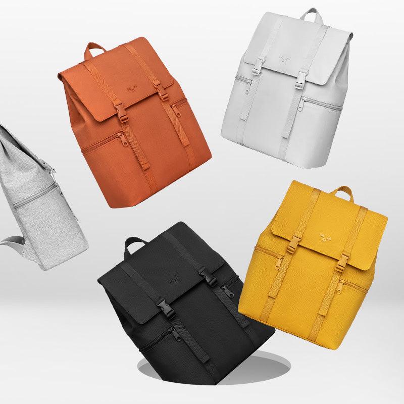 Stylish backpacks in orange, white, gray, black, and yellow with multiple pockets and buckles