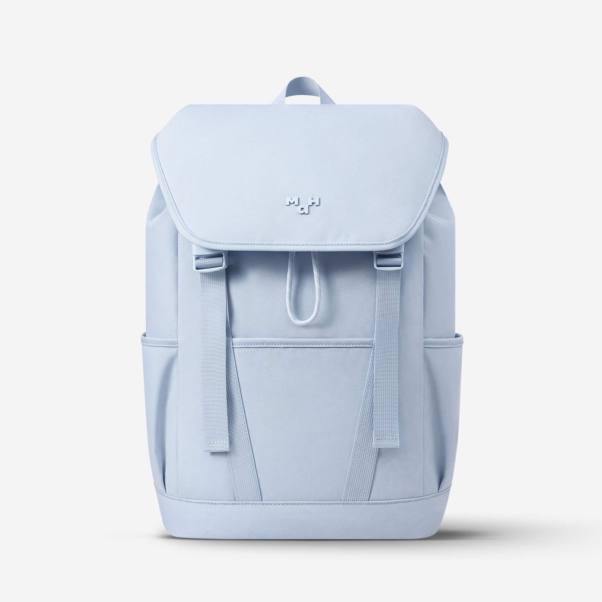 Light blue minimalist backpack with front flap, side pockets, and adjustable straps for daily use