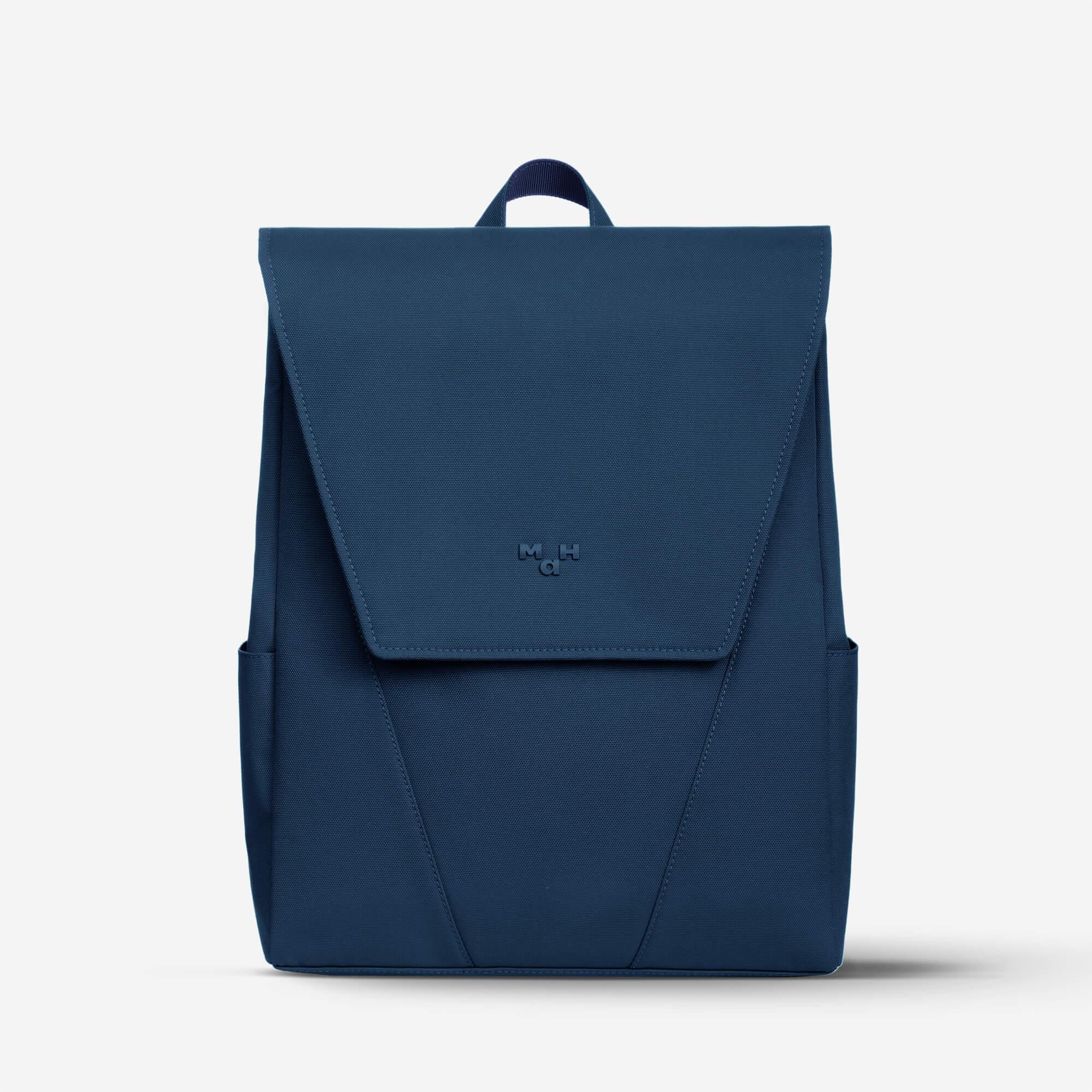 Navy blue minimalist backpack with front flap and side pockets, ideal for daily use or travel
