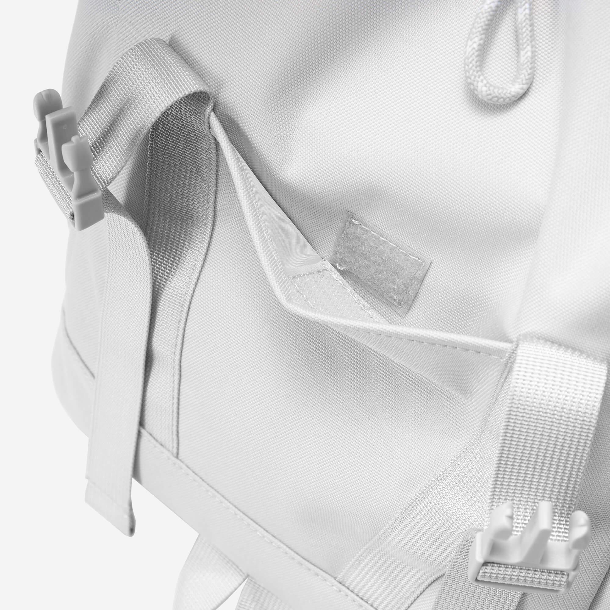 White backpack with adjustable straps and side pocket, featuring durable fabric and secure buckles