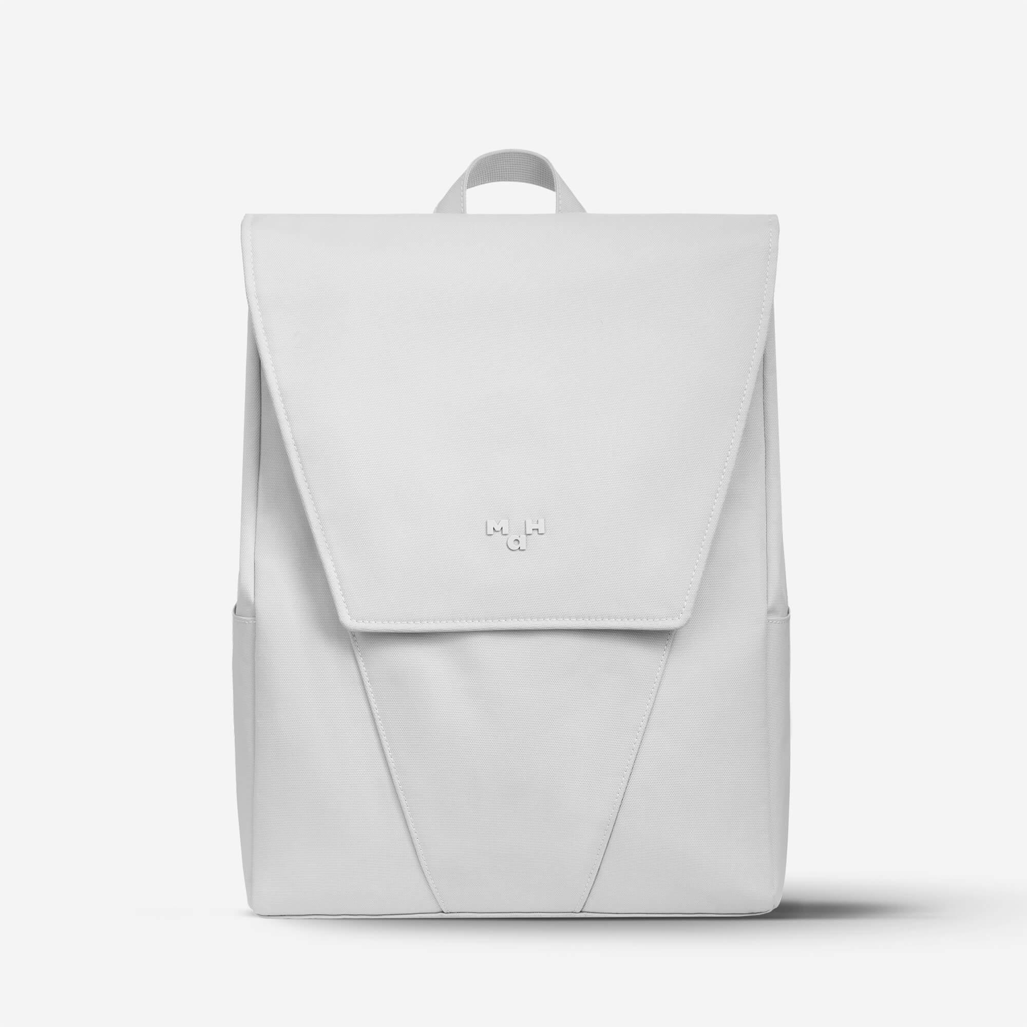 Minimalist white backpack with flap closure and subtle logo, ideal for daily use or travel