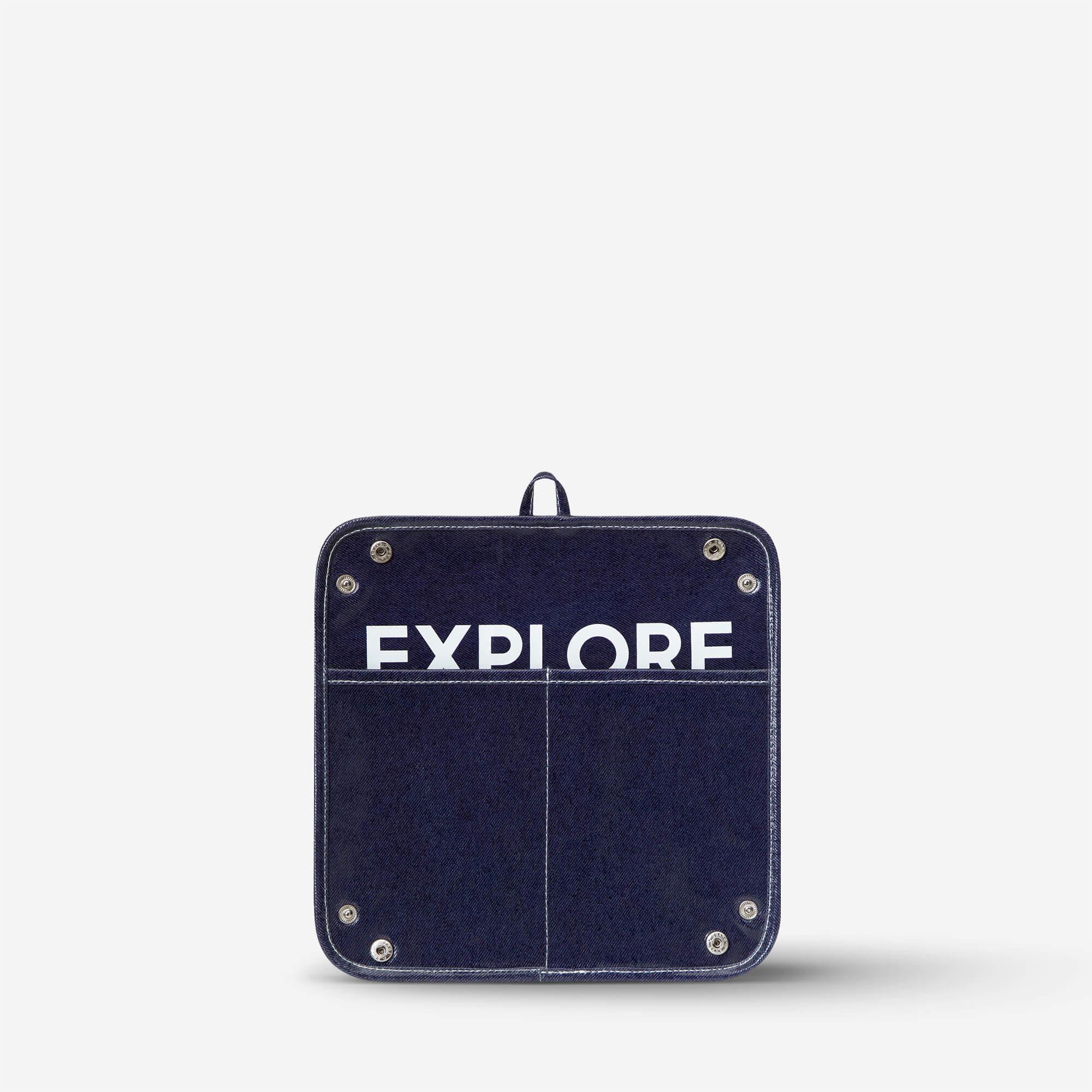 Navy denim pouch with 'EXPLORE' print, metal rivets, and front pockets for travel or daily use