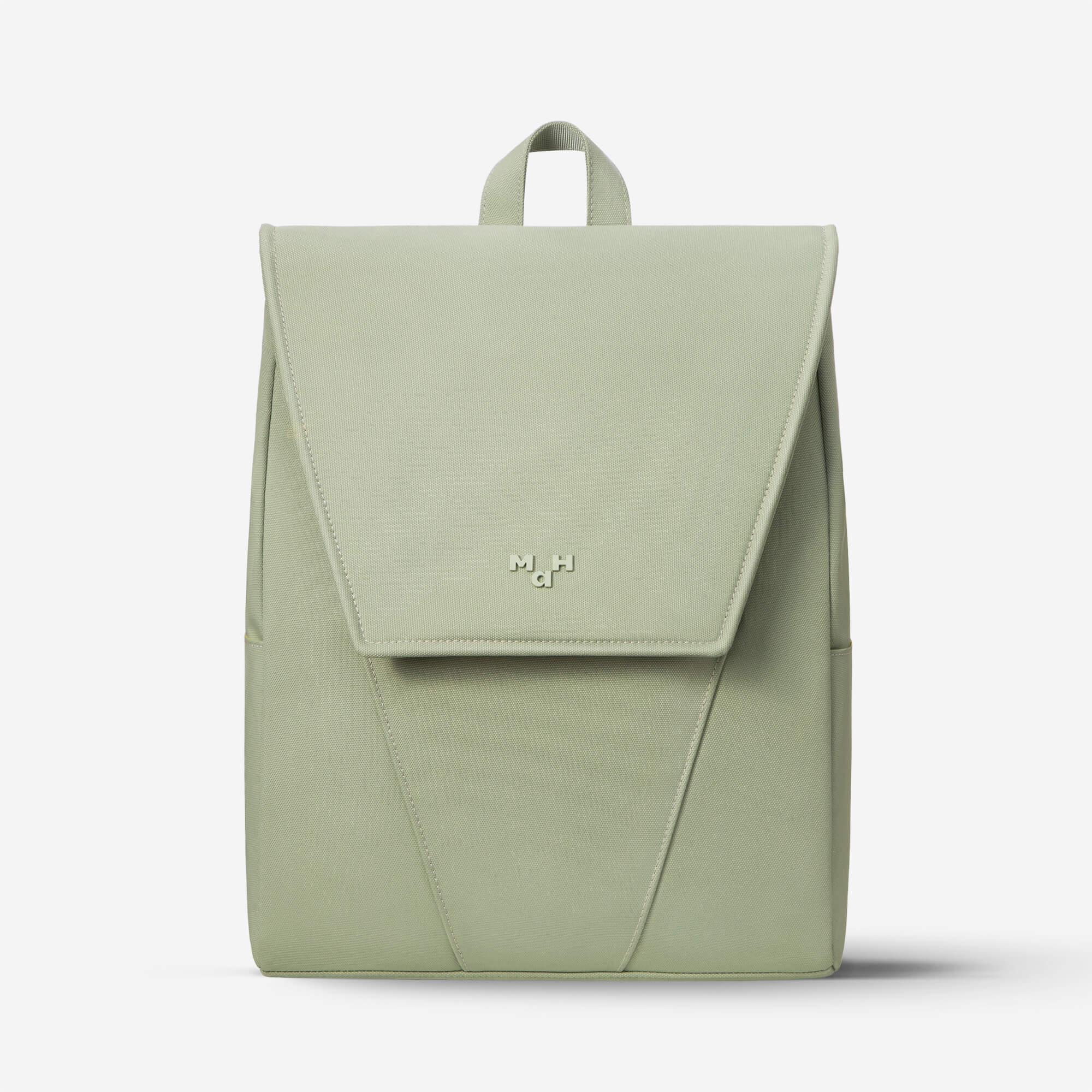 Light green minimalist backpack with front flap and subtle logo, ideal for daily use or travel