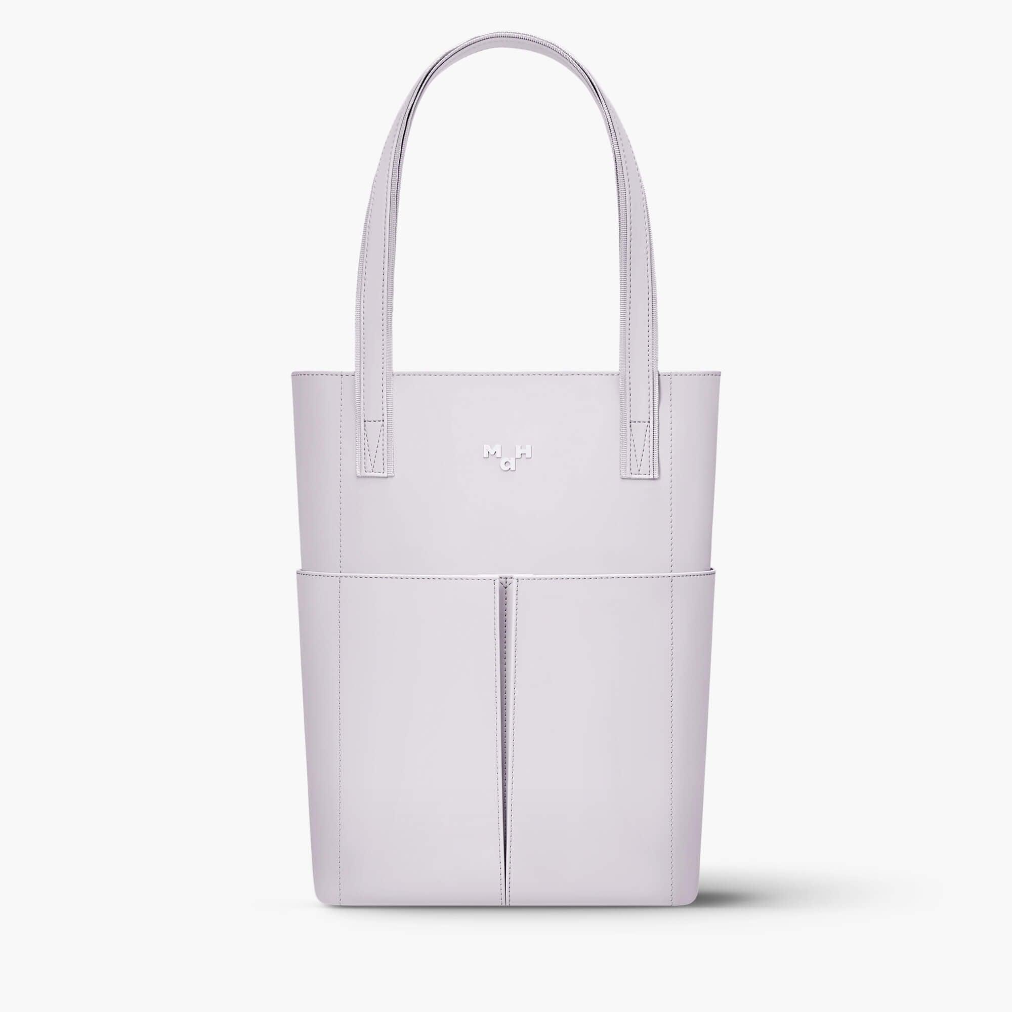 Light purple minimalist tote bag with front pockets and sleek handles, ideal for everyday use