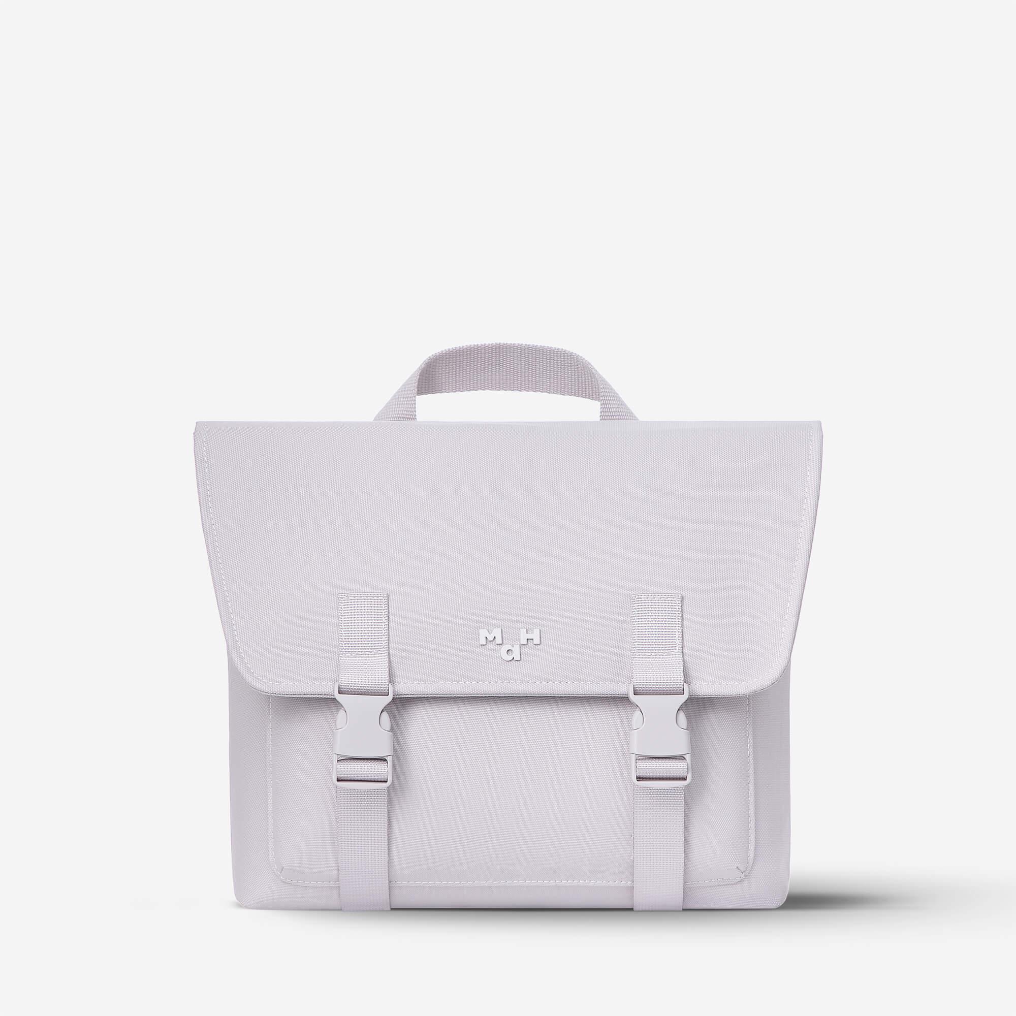 Light purple satchel bag with top handle and buckle straps, minimalist design for everyday use
