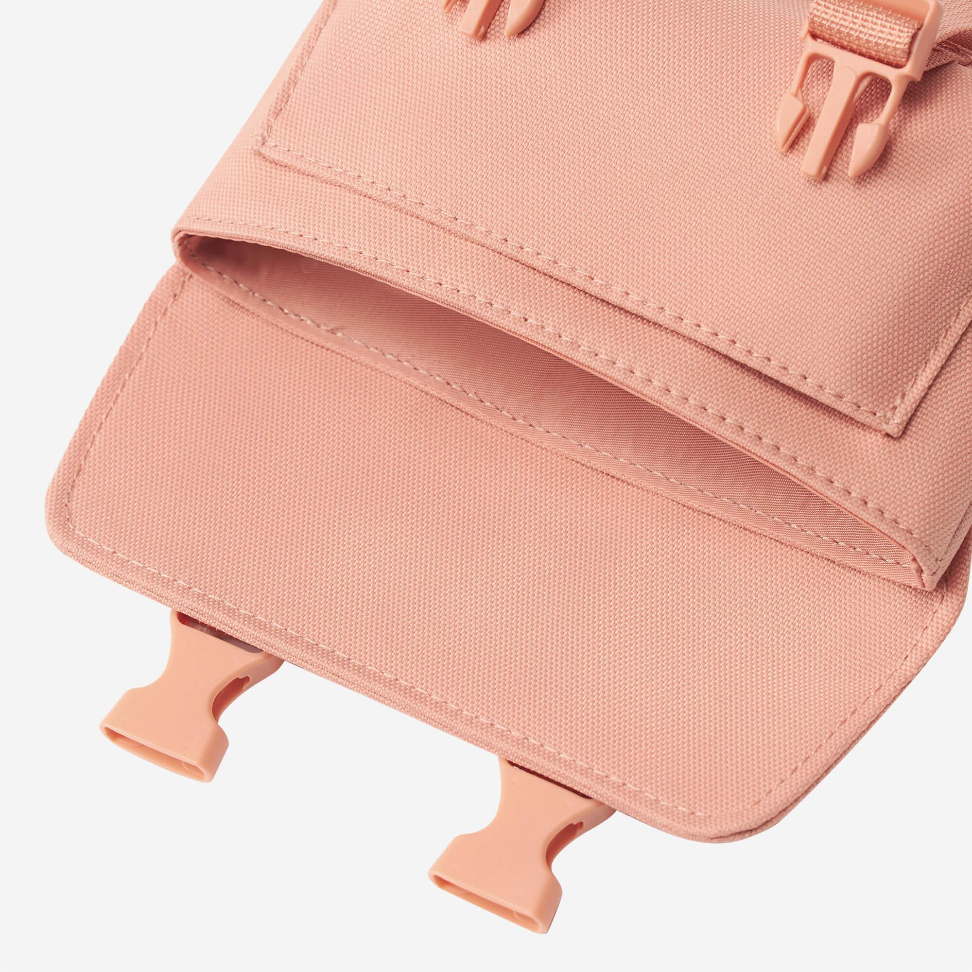 Pink canvas bag with adjustable straps and secure buckles, ideal for everyday carry