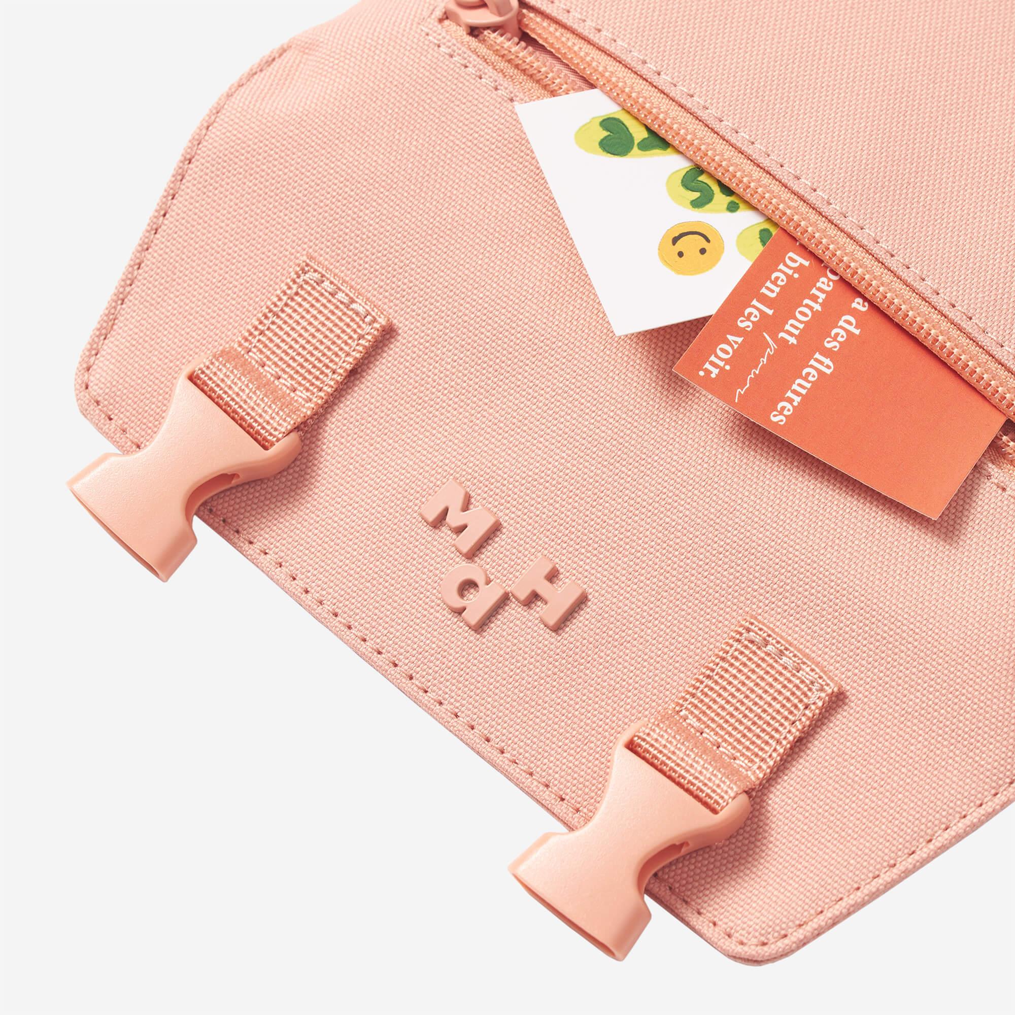 Pink MaH accessory pouch with zipper, buckles, and branded tag, ideal for travel or daily use.