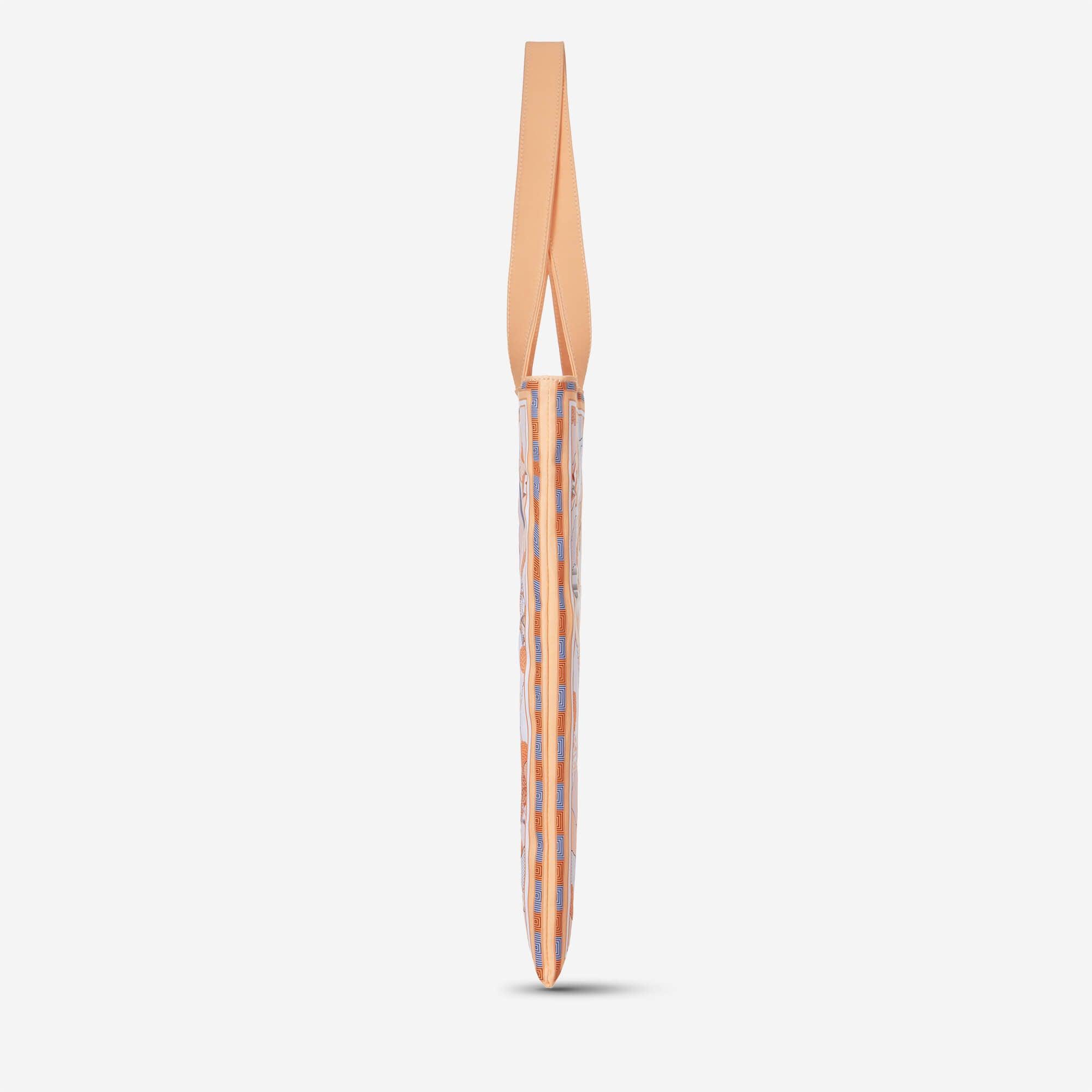 Peach tote bag with geometric blue and orange pattern, side view on white background