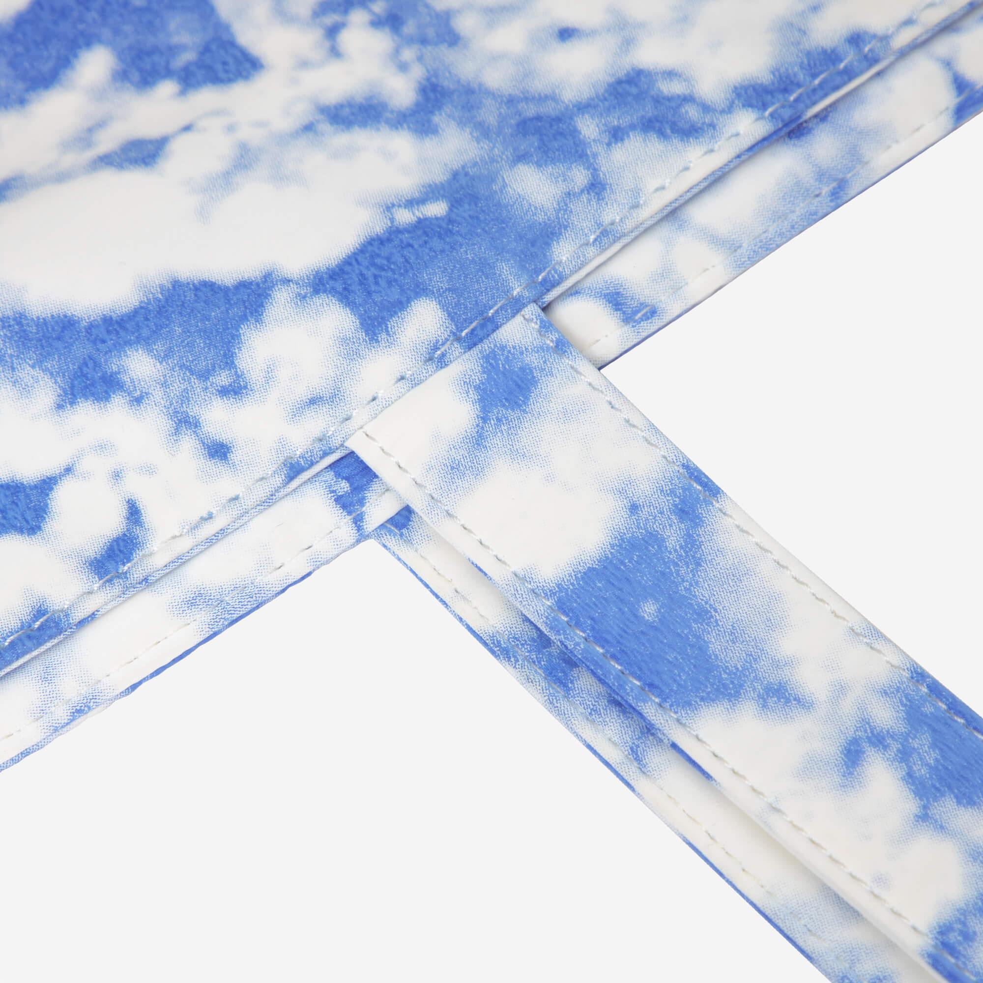 Blue and white tie-dye bag strap with clean stitching detail
