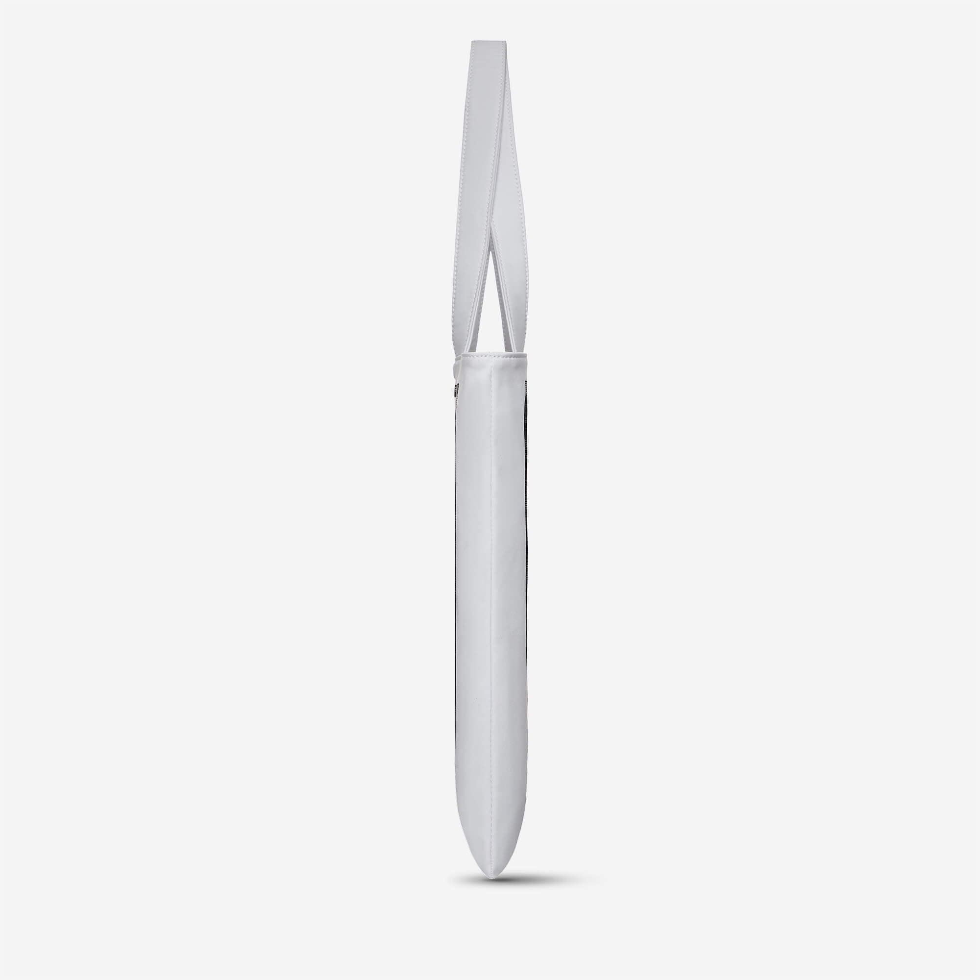 Minimalist white tote bag with long strap, sleek design for everyday carry