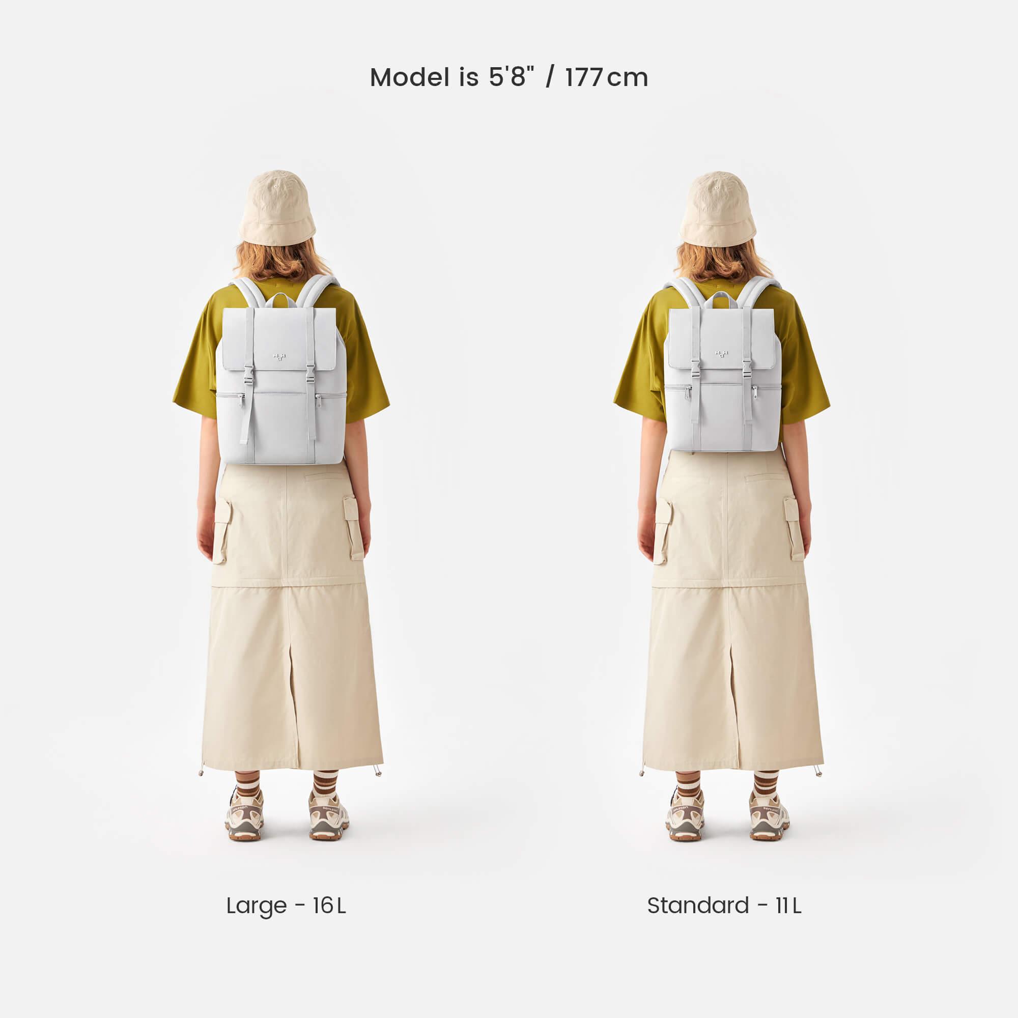 White backpack in large 16L and standard 11L sizes, worn by model in olive tee and beige skirt