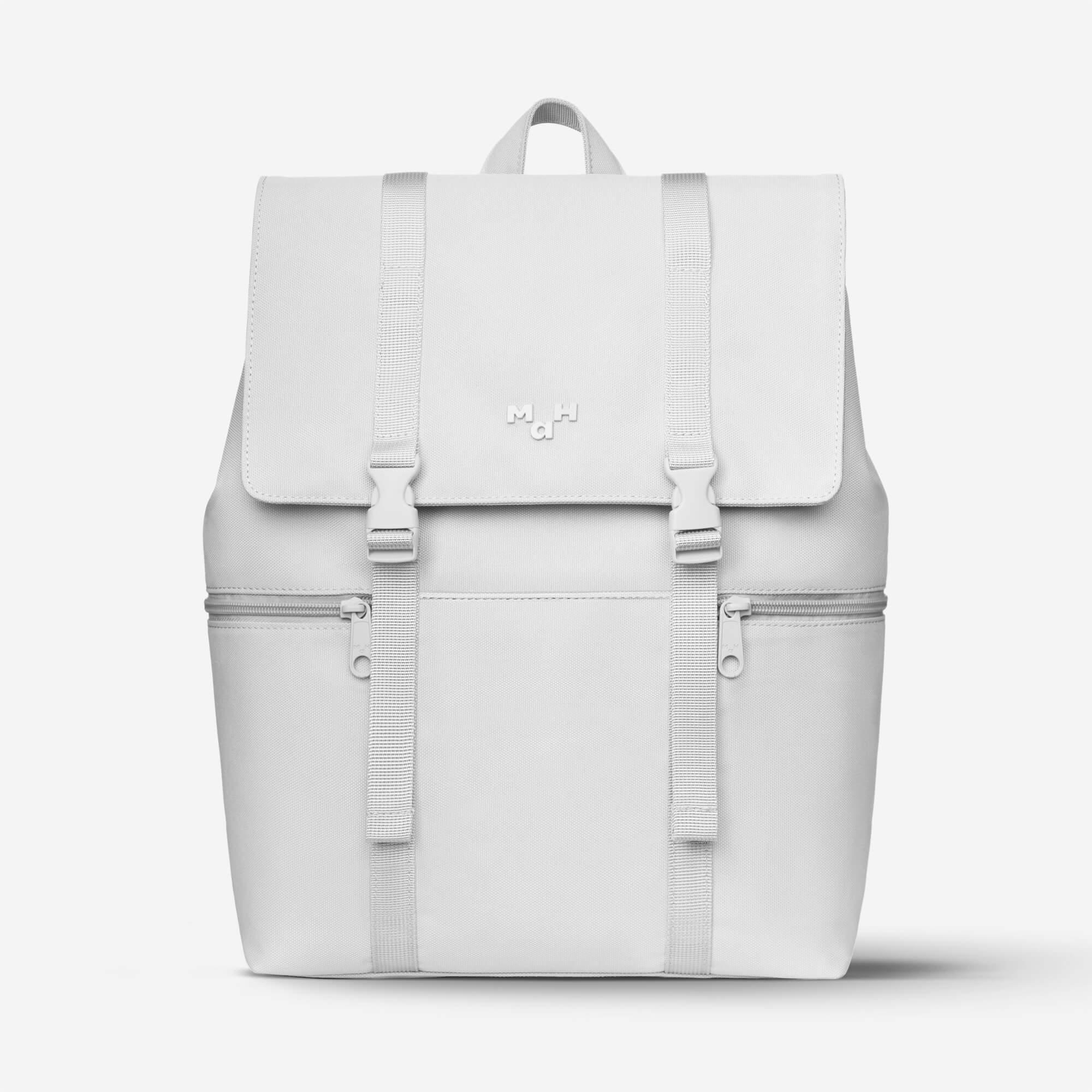 Minimalist white backpack with front flap, buckles, and side zippers for everyday use
