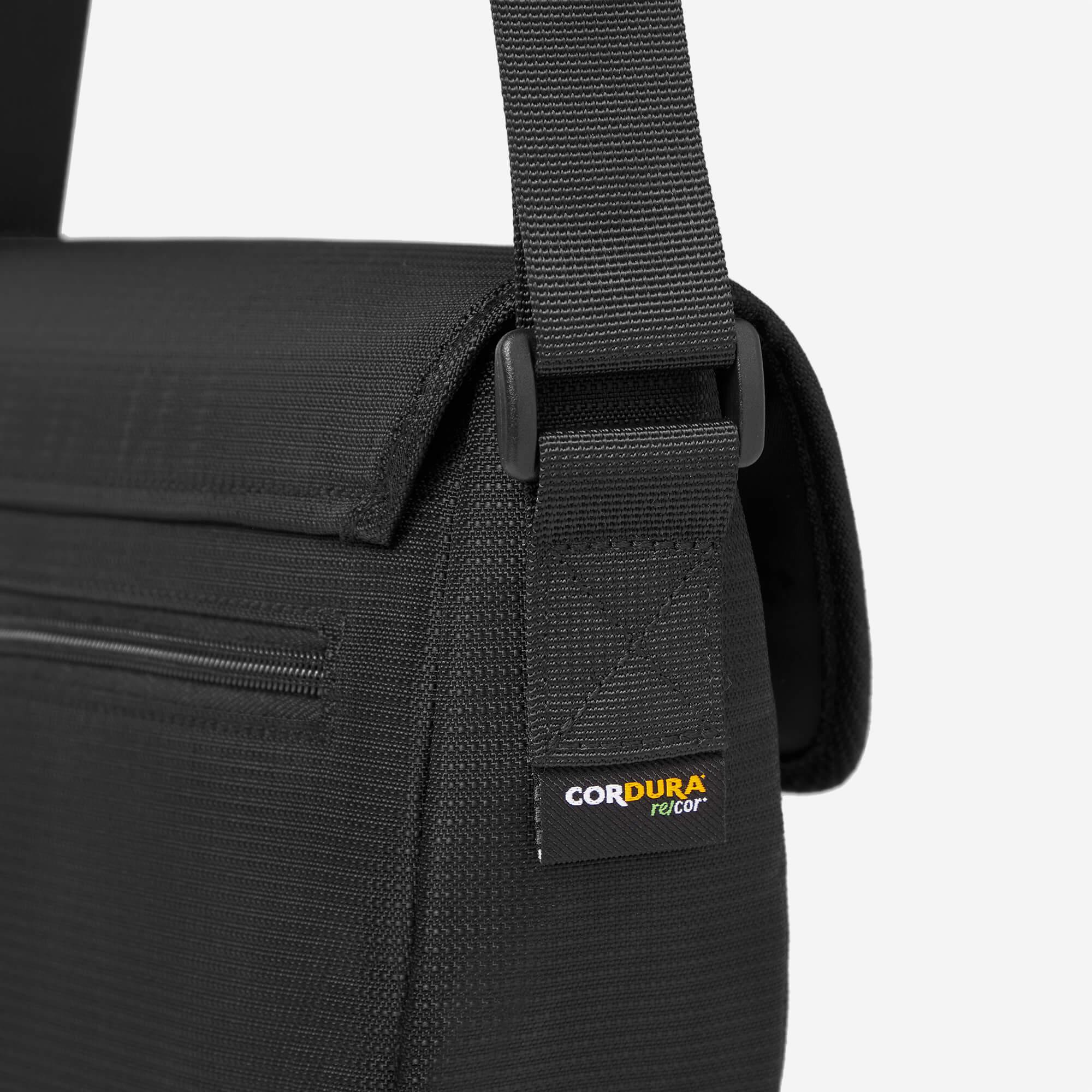 Black durable messenger bag with CORDURA fabric and adjustable strap detail