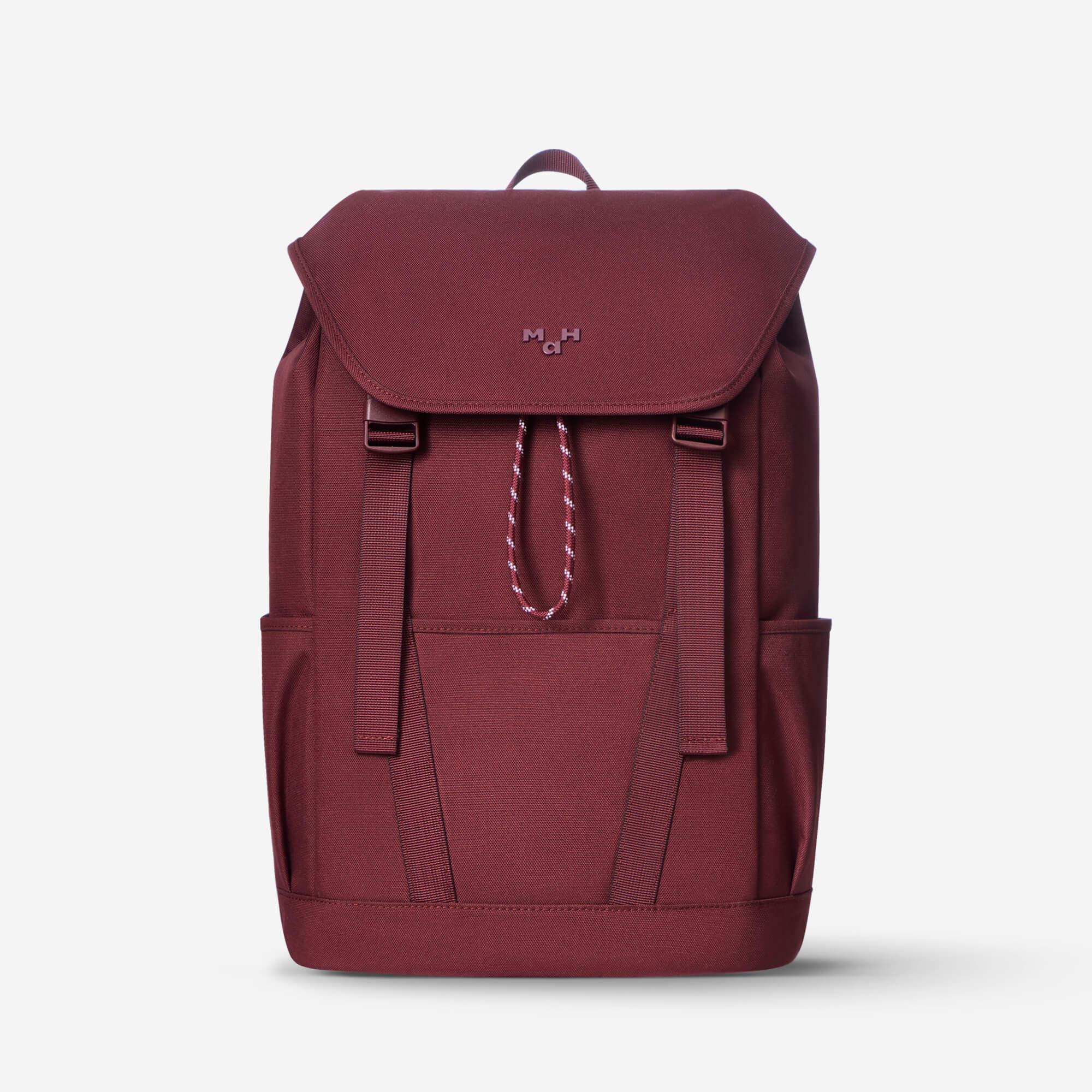 Burgundy canvas backpack with front pocket, drawstring closure, and side straps for daily use or travel