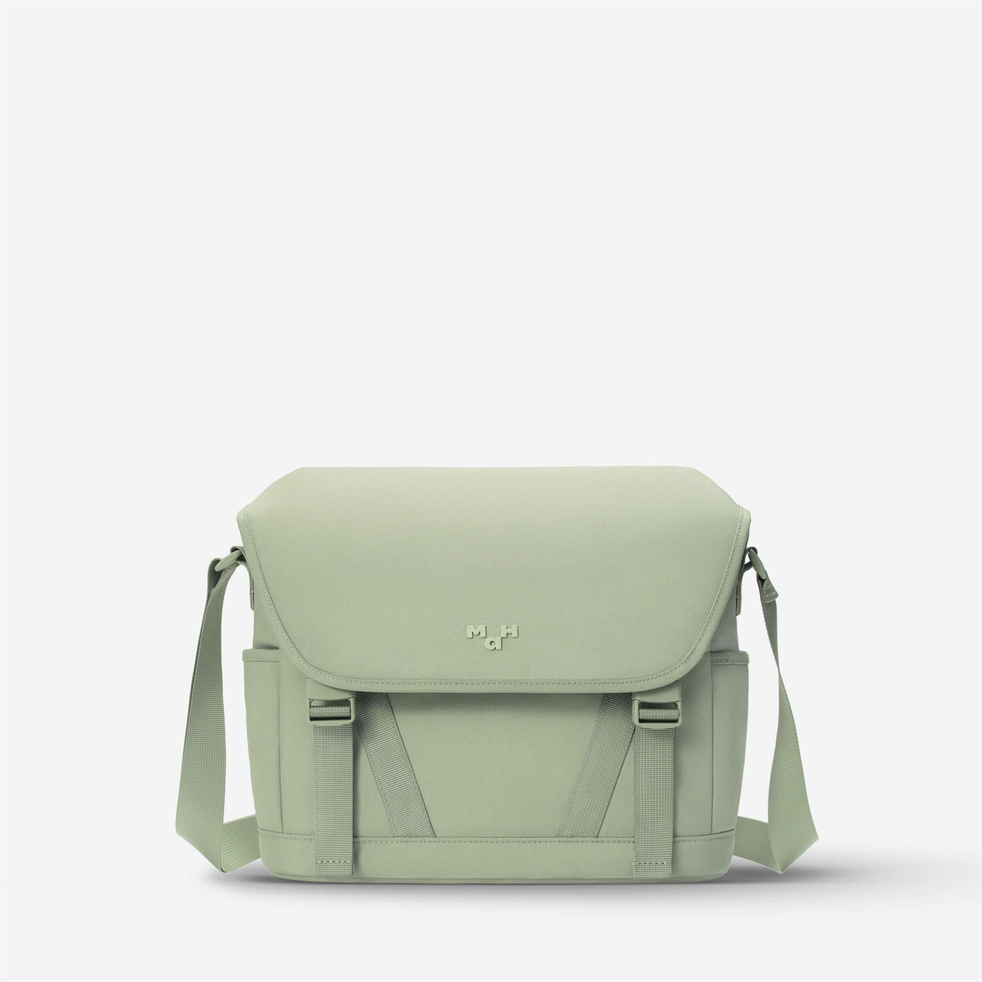 Mint green messenger bag with adjustable strap and front flap, ideal for everyday carry and urban style.
