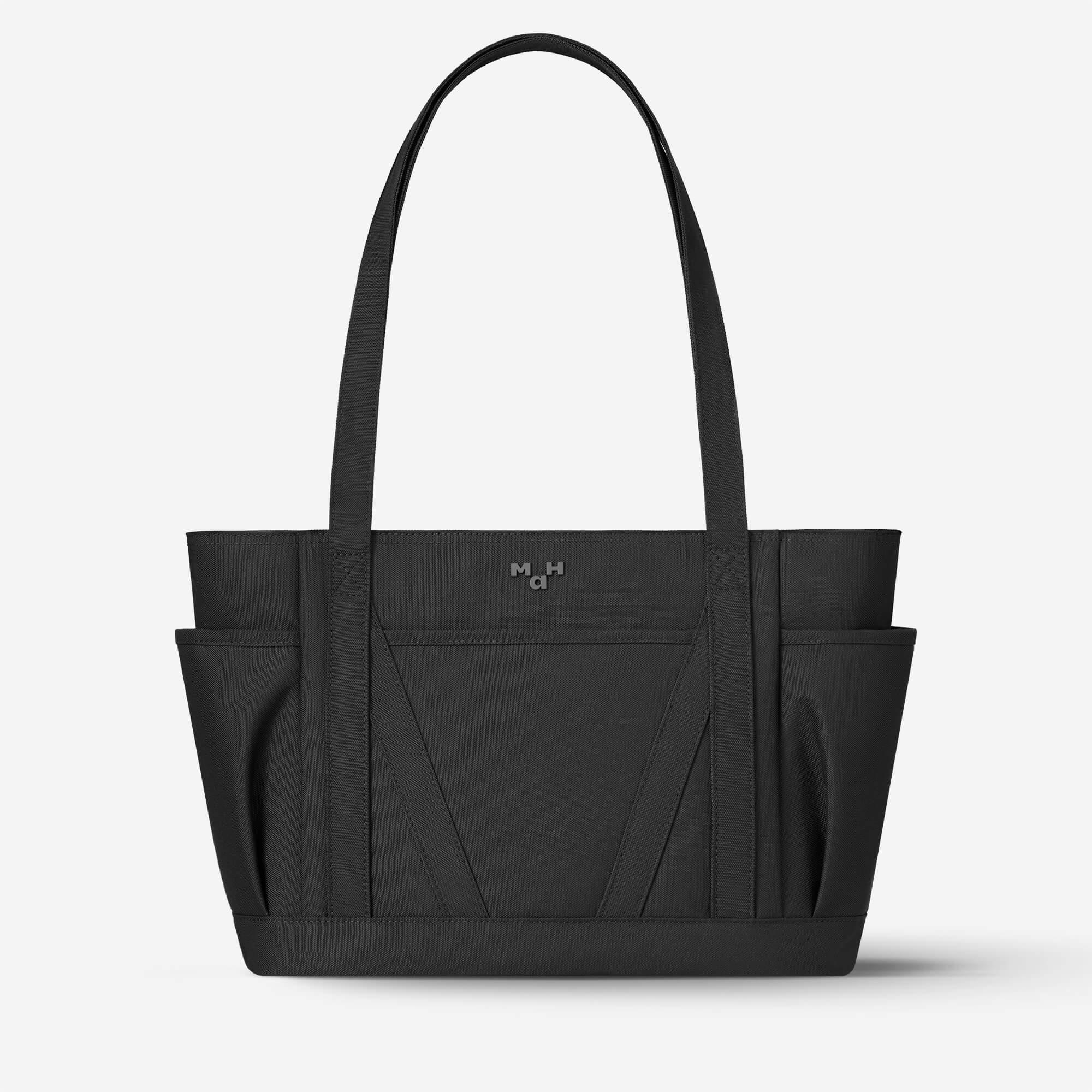 Black tote bag with side pockets and minimalist design, ideal for everyday carry and lifestyle use.