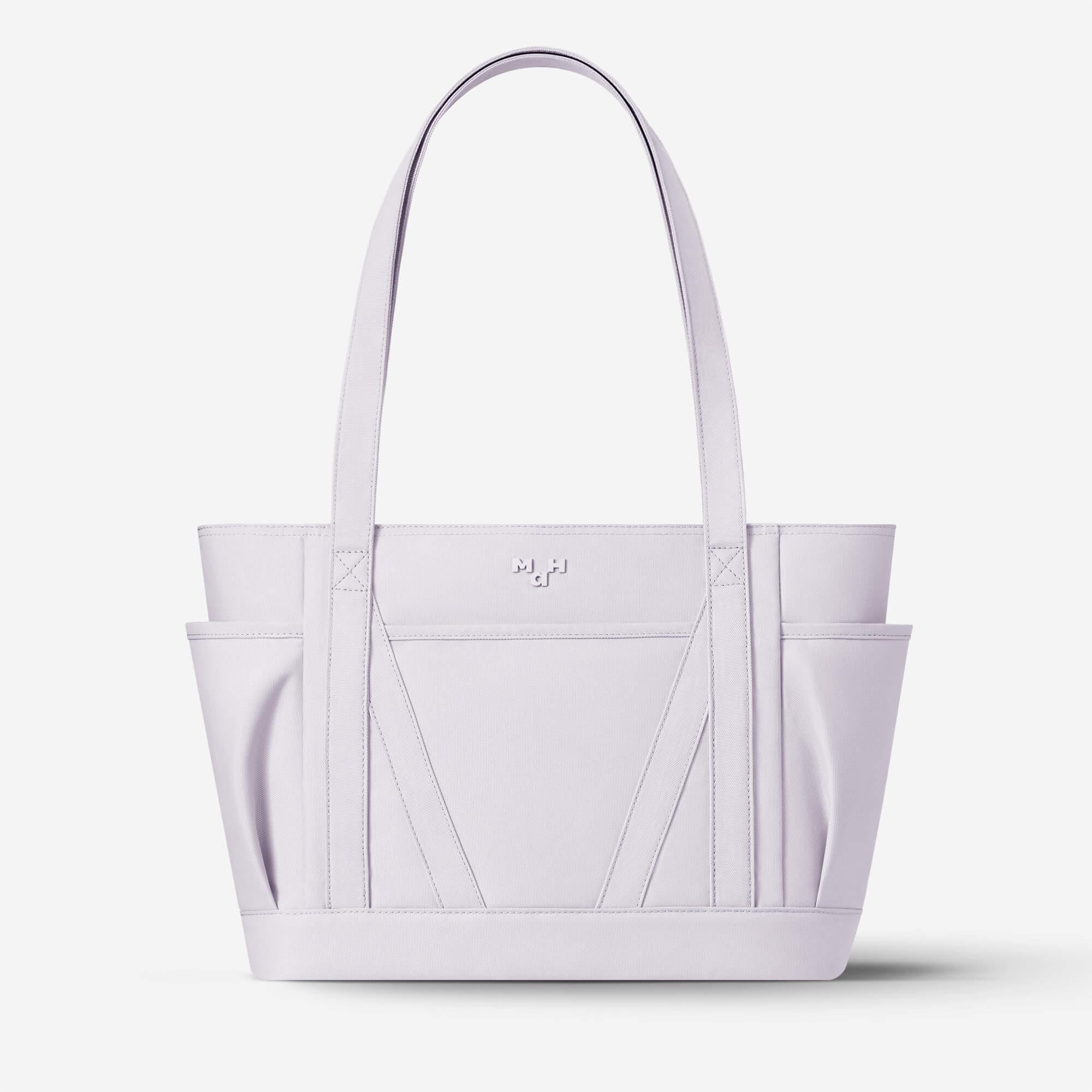Light purple tote bag with structured design, dual handles, and front pockets for everyday carry