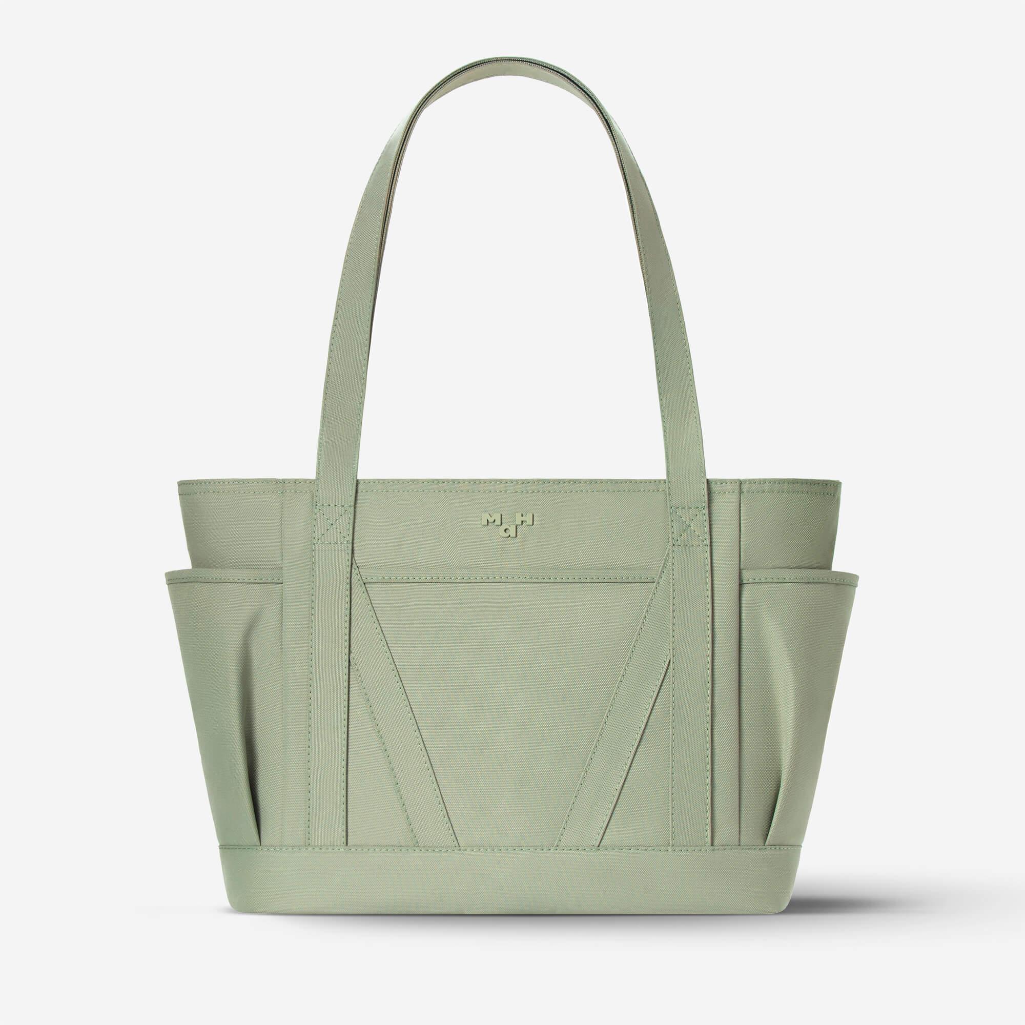 Mint green canvas tote bag with side pockets and logo, ideal for everyday use or shopping.