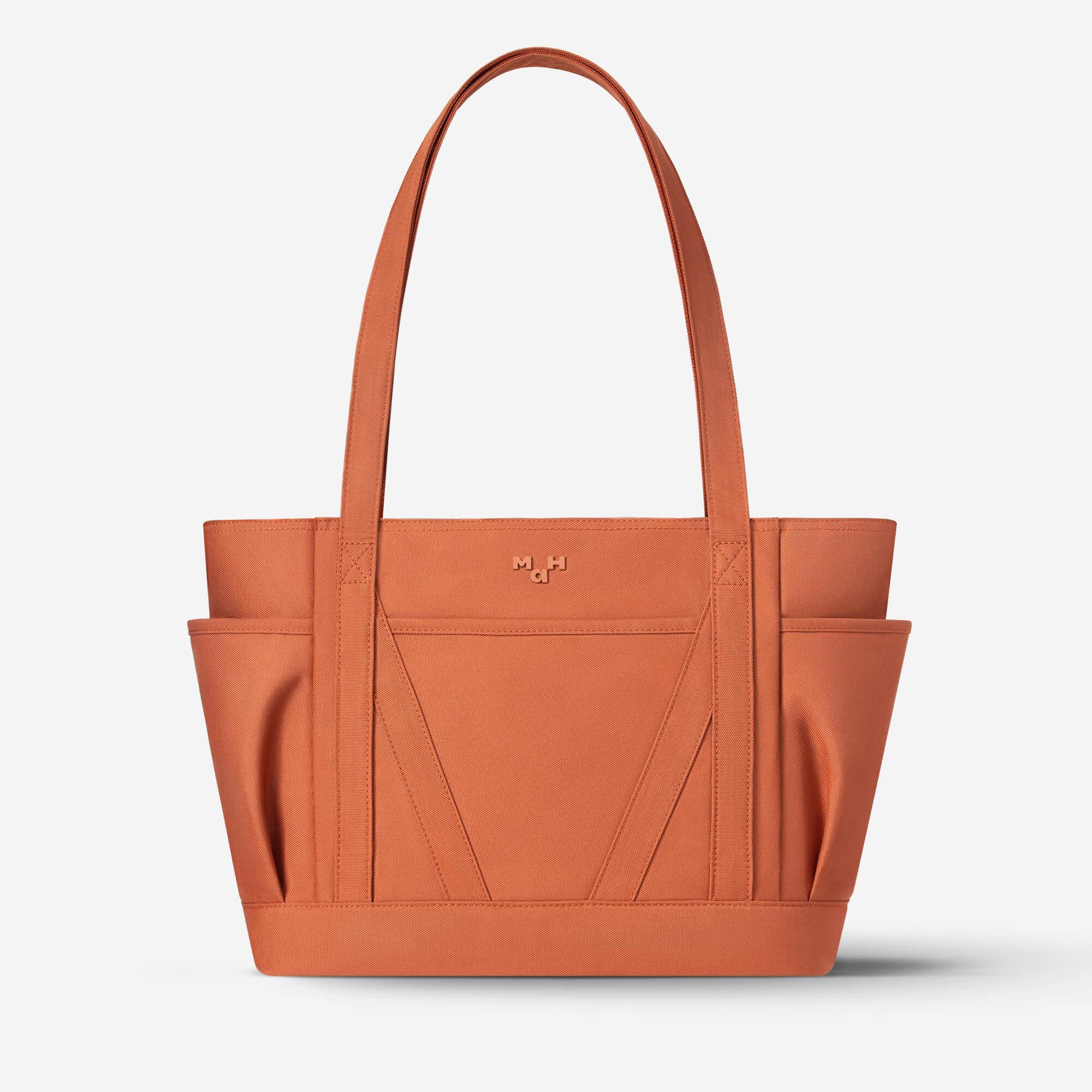 Rust orange tote bag with side pockets and minimalist design, ideal for daily use or shopping.