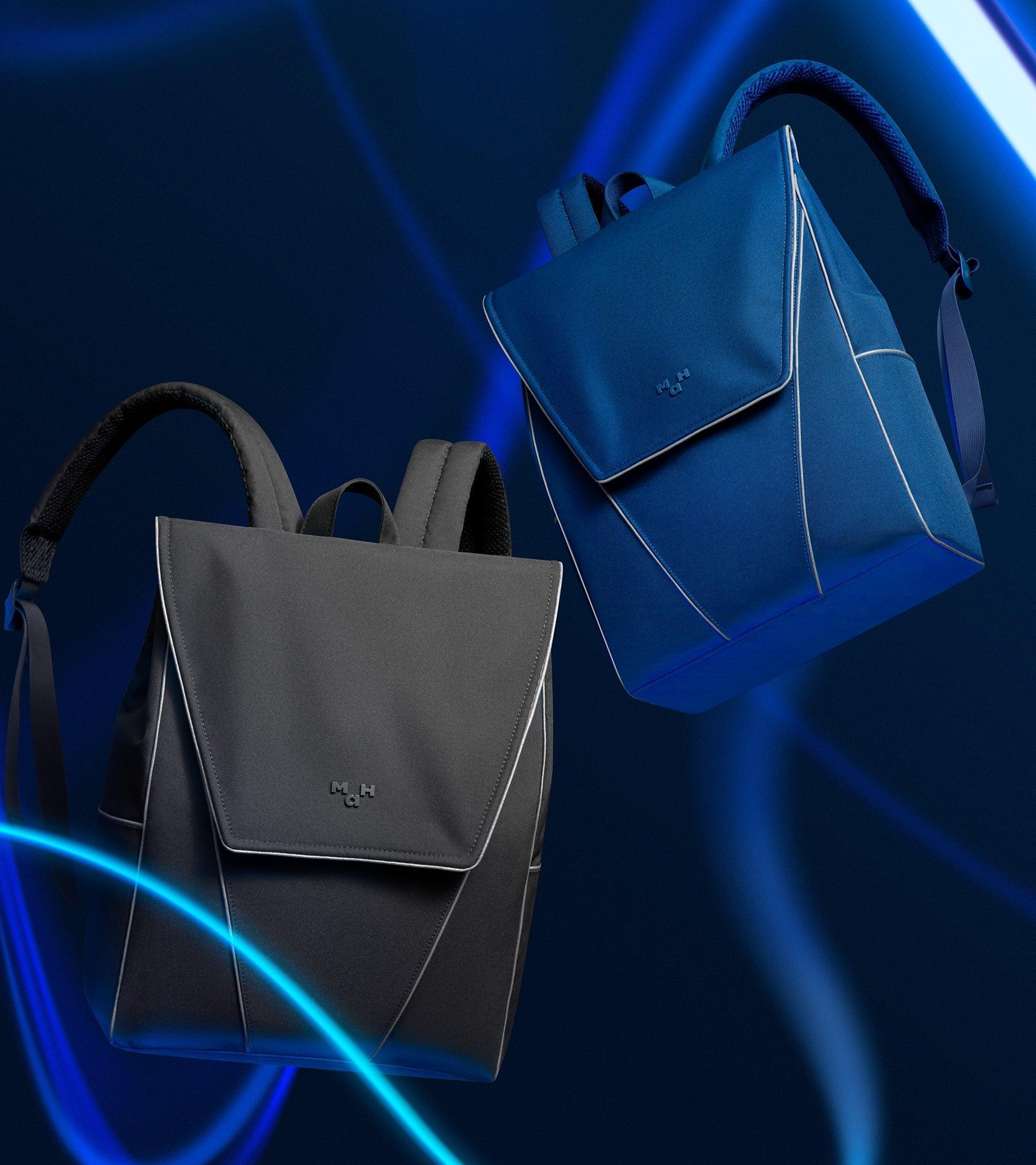 Stylish black and blue minimalist backpacks with sleek design and contrast stitching against neon blue light