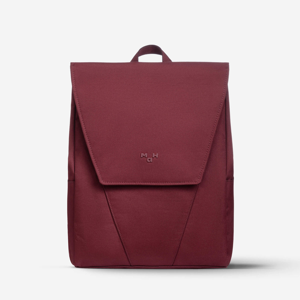 Burgundy minimalist backpack with flap closure and top handle, ideal for daily use or travel