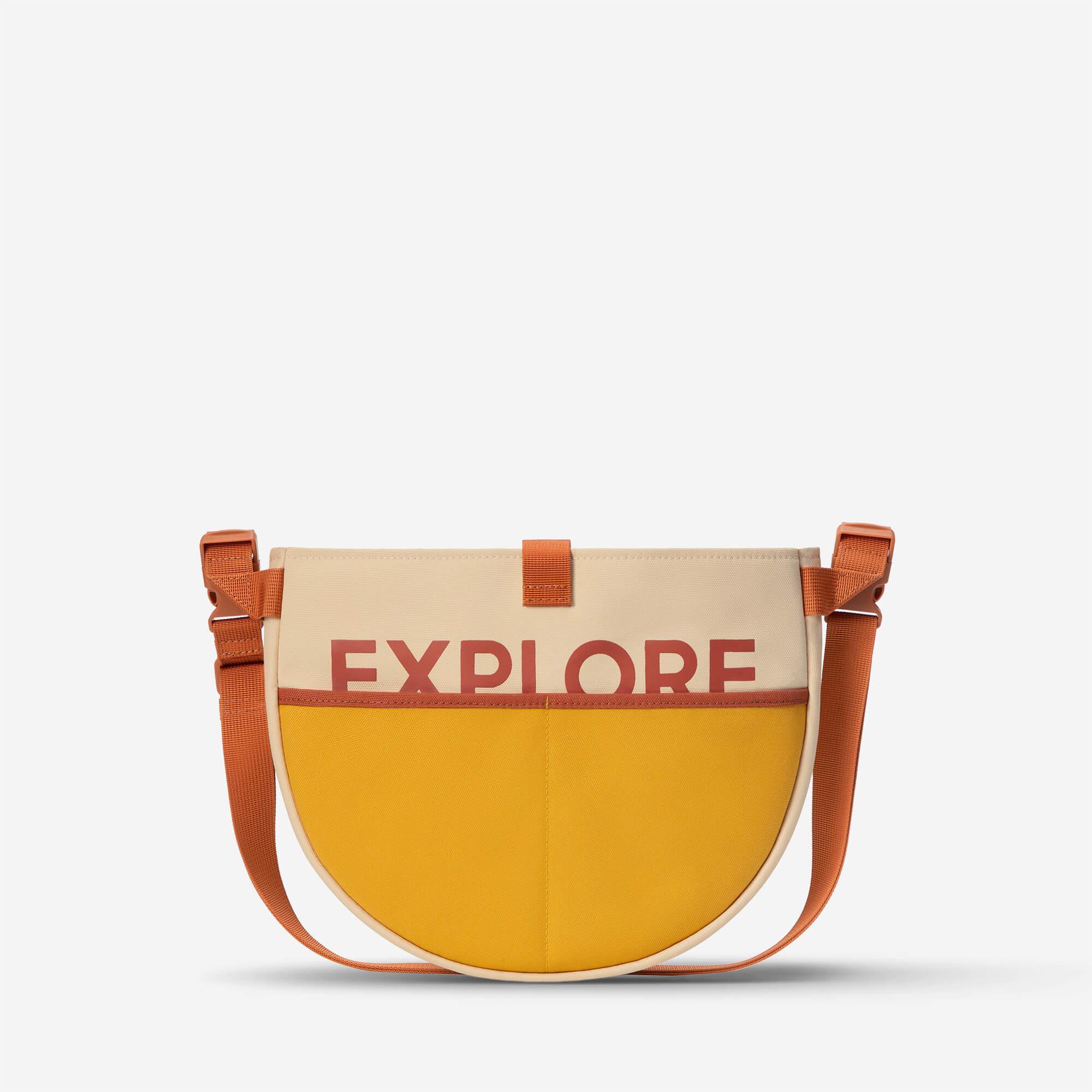 Explore print crossbody bag with yellow and beige panels, orange strap for travel or daily use