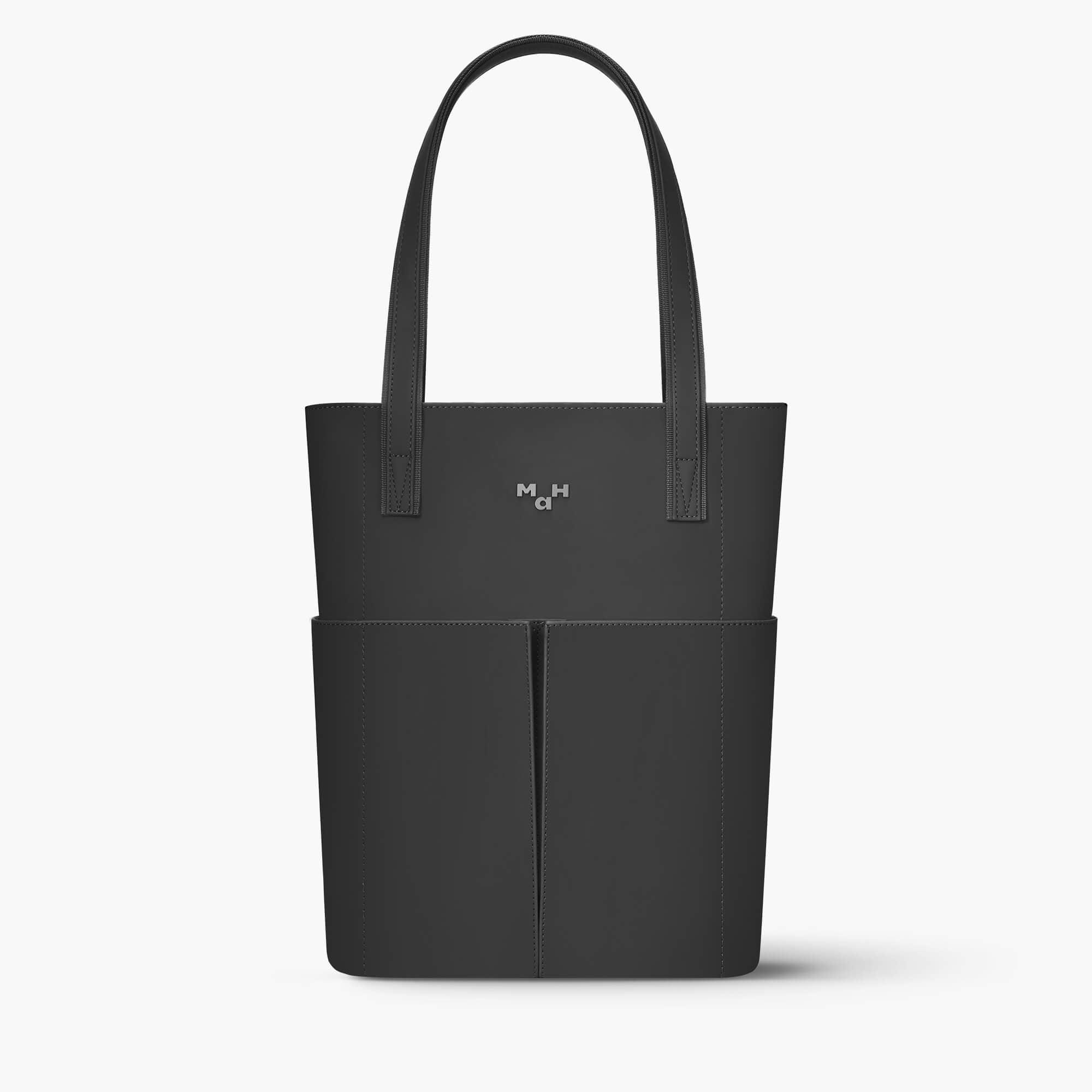 Black minimalist tote bag with front pockets and sleek handles, ideal for everyday use