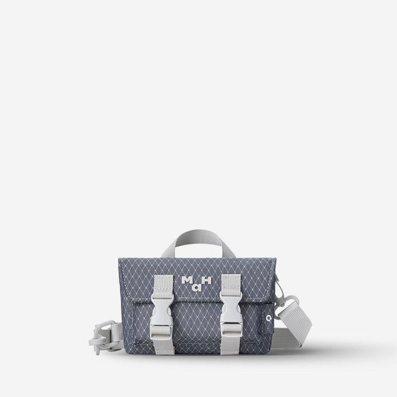 Compact gray crossbody bag with geometric pattern, adjustable straps, and front buckles for everyday carry