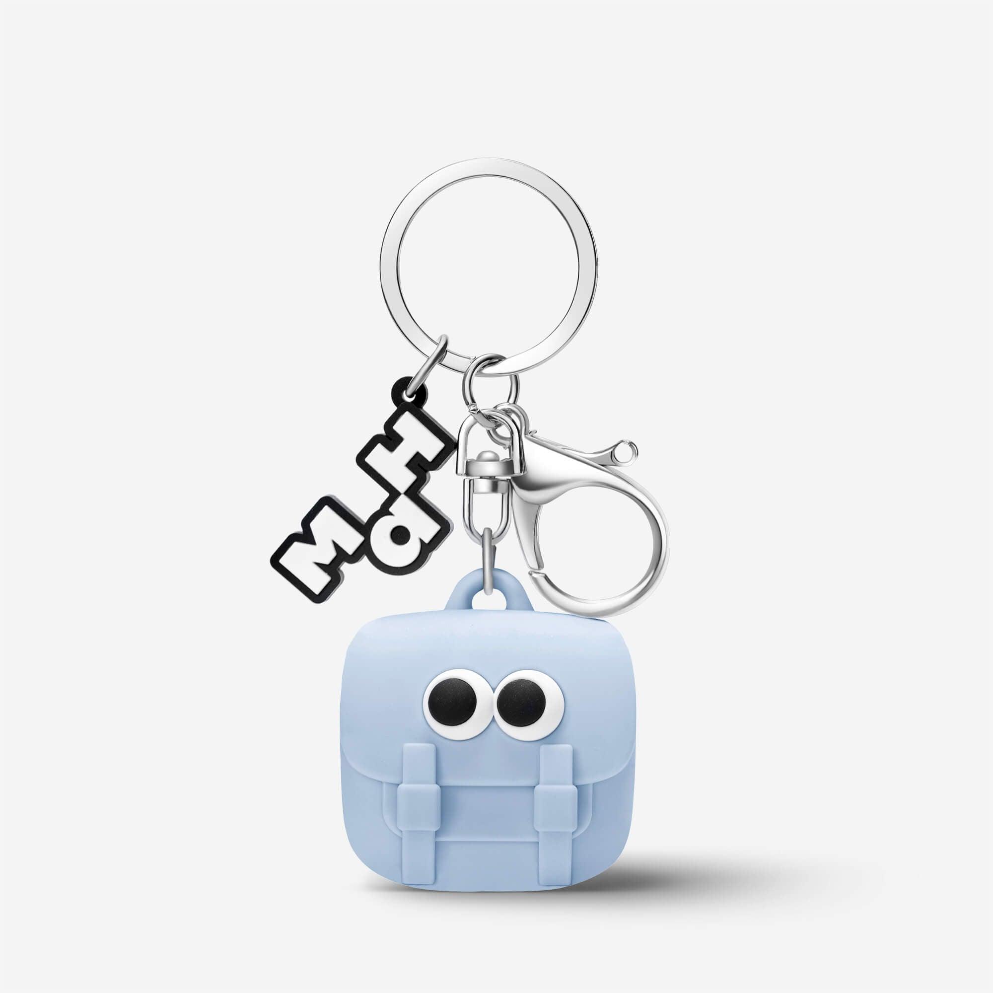 Cute light blue backpack keychain with googly eyes and MH logo charm, perfect accessory for bags or keys.