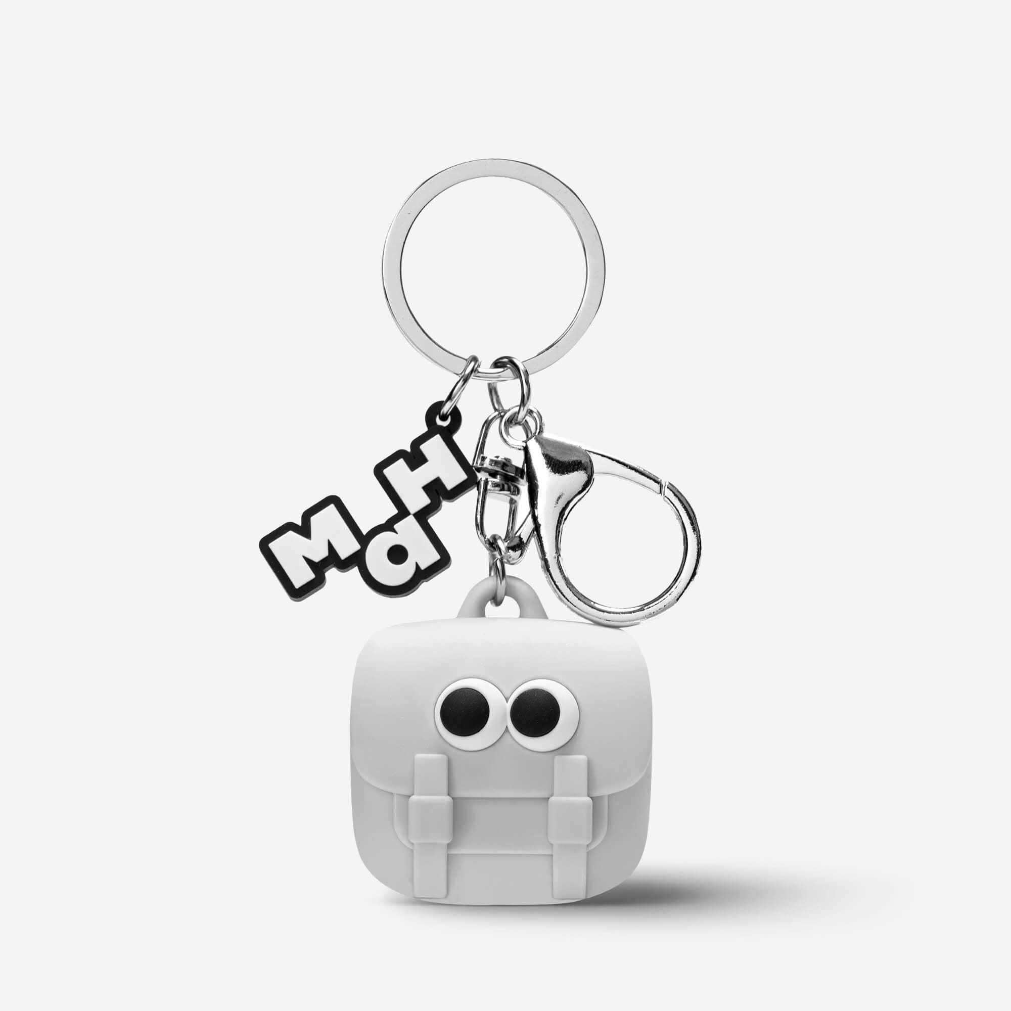 Cute white backpack keychain with big eyes, silver ring, and MH logo charm, perfect for bags and accessories.