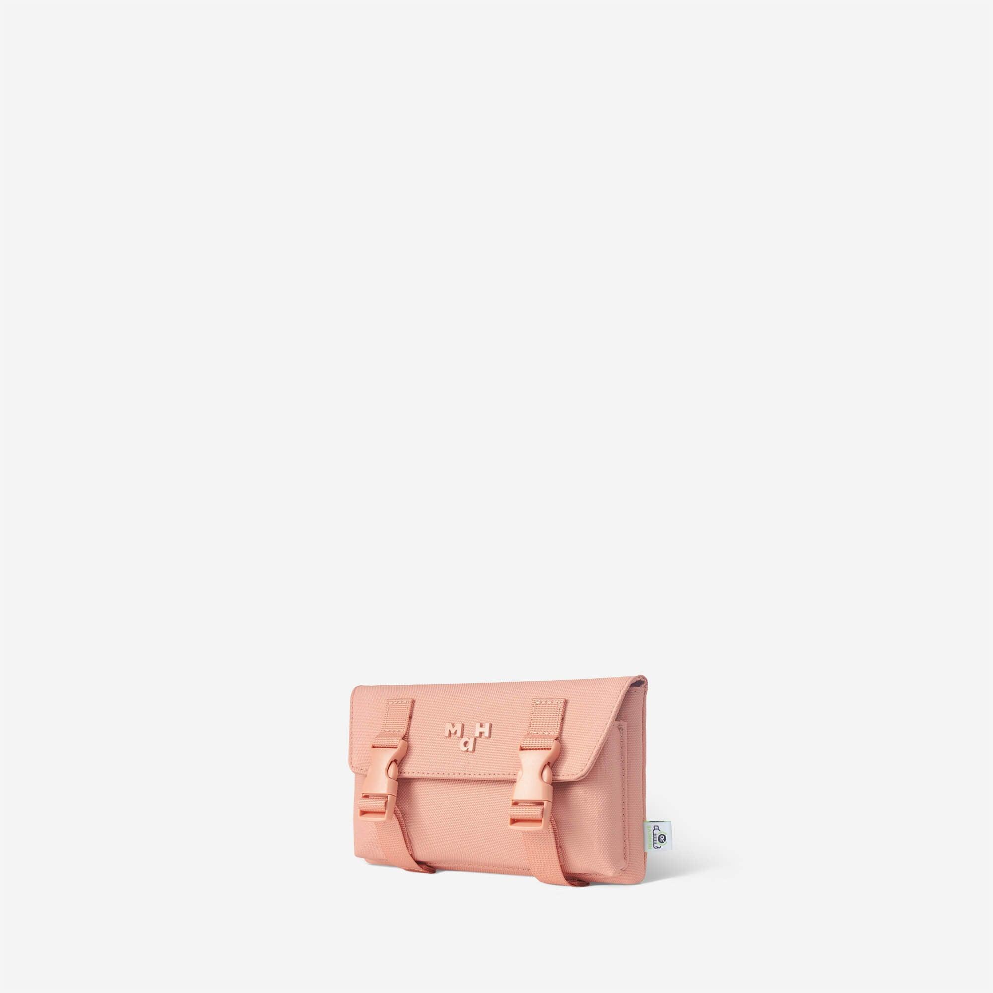 Pink minimalist crossbody bag with buckle straps and logo detail, ideal for everyday use