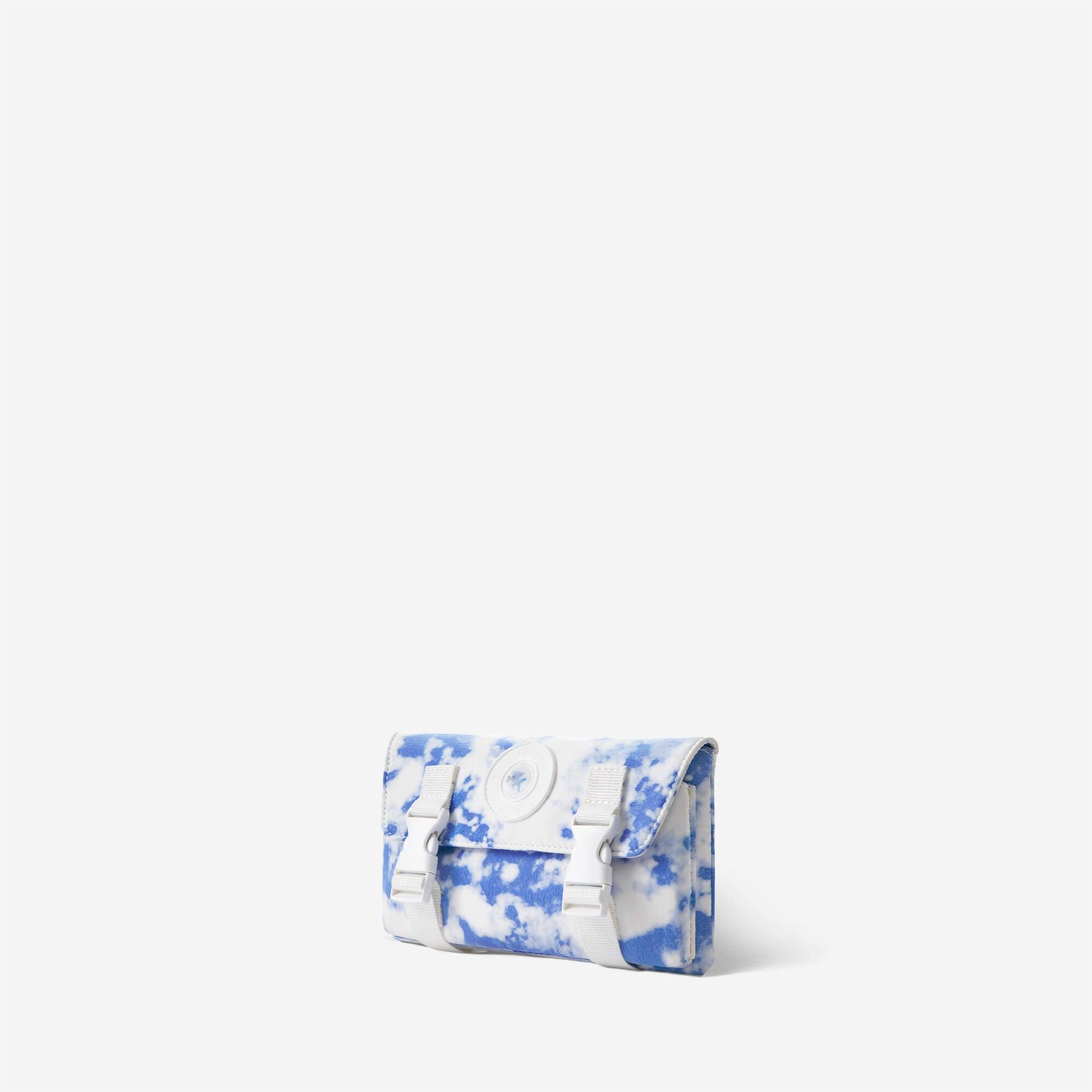 Blue and white tie-dye crossbody bag with adjustable straps and front buckle closure