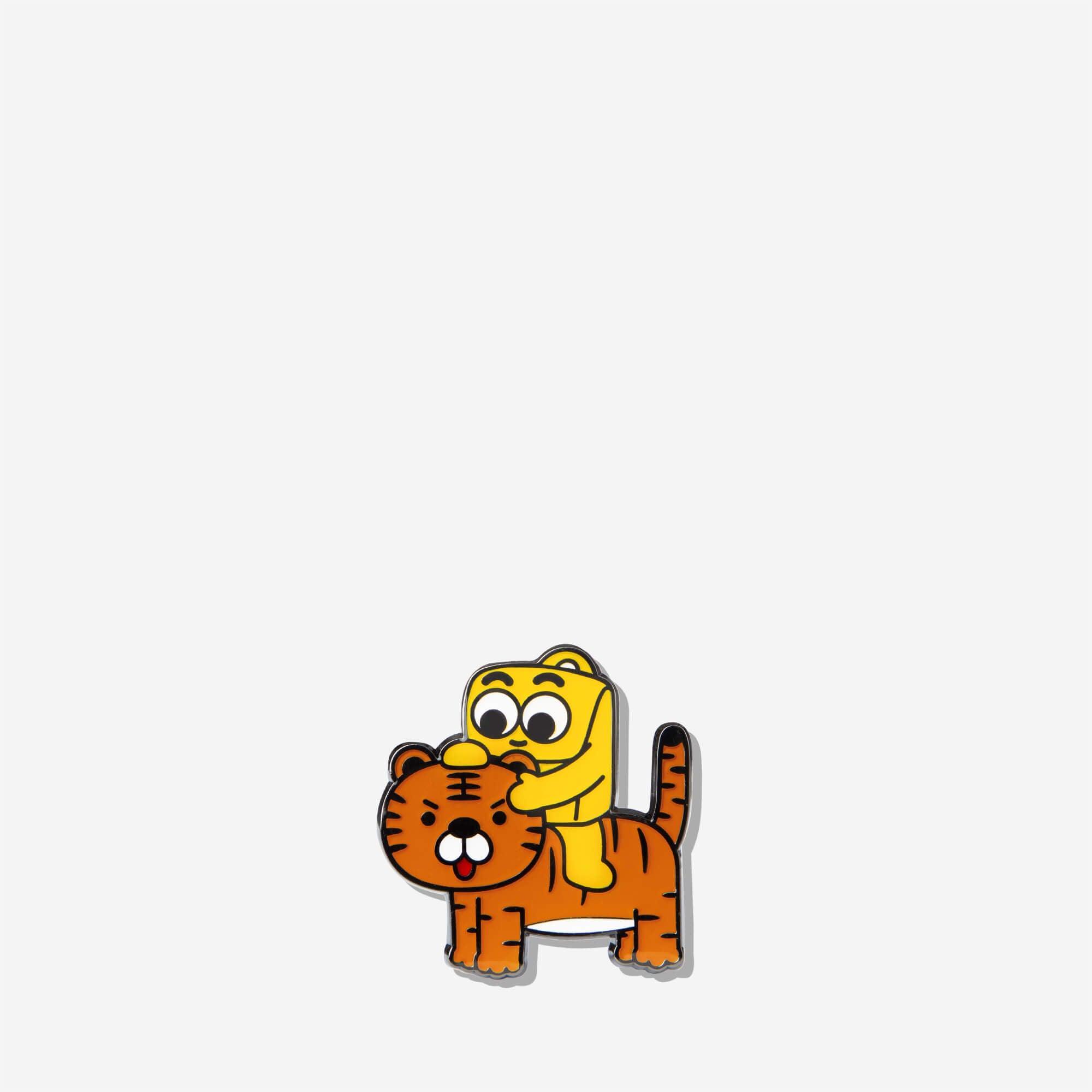 Cute cartoon enamel pin of yellow character hugging orange tiger, fun accessory for bags or jackets