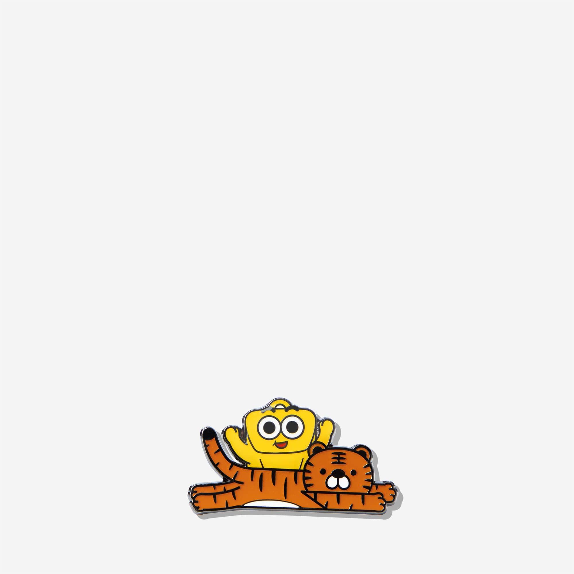 Cute enamel pin featuring a yellow character riding a striped tiger, fun accessory for bags or jackets.