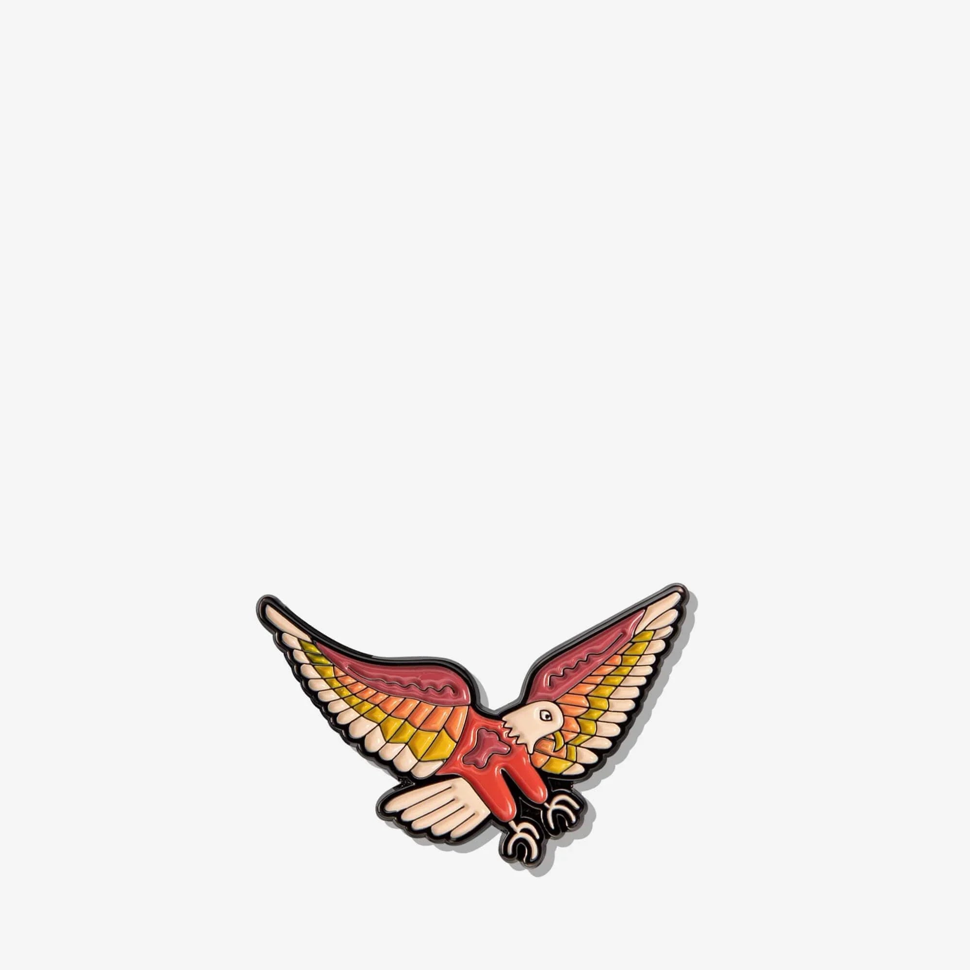 Colorful enamel bird pin with spread wings, red body, yellow-orange feathers, and black outline for bags or accessories