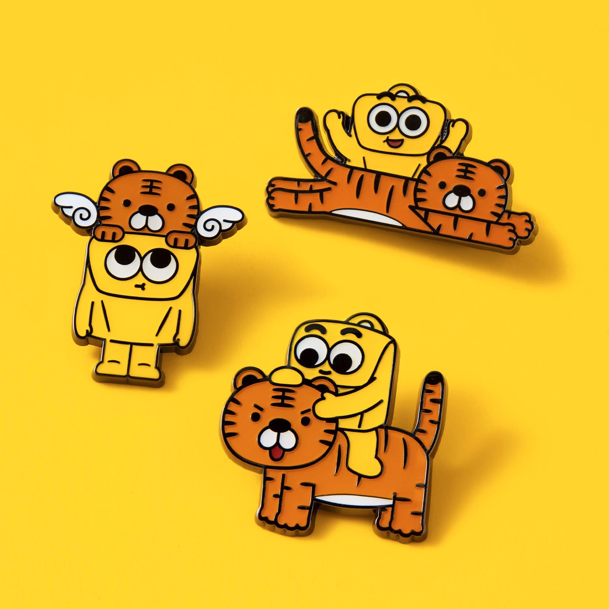Cute cartoon tiger and character enamel pins, playful designs on yellow background
