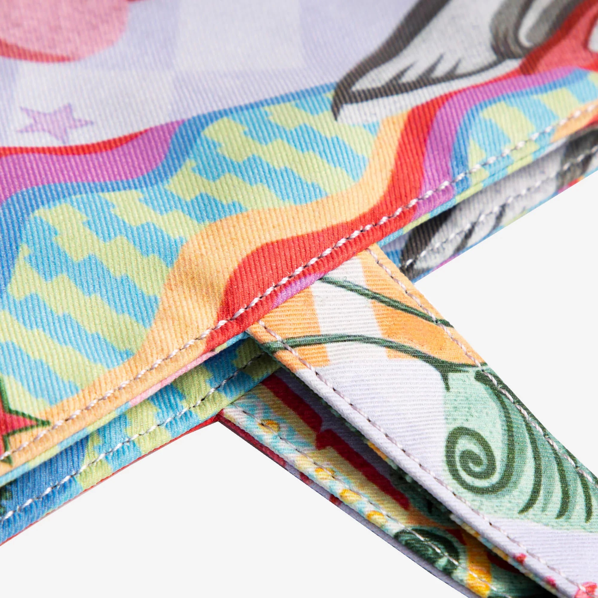 Colorful patterned fabric bag with vibrant rainbow designs and detailed stitching