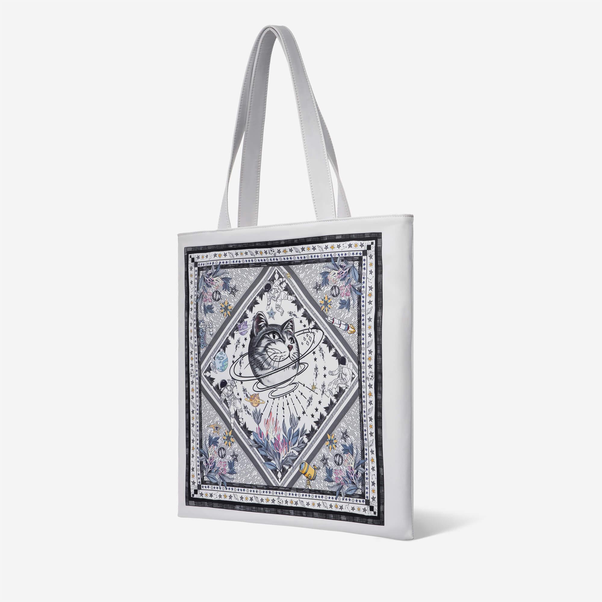 White tote bag with cosmic cat print, space astronauts, planets, and floral details for everyday use