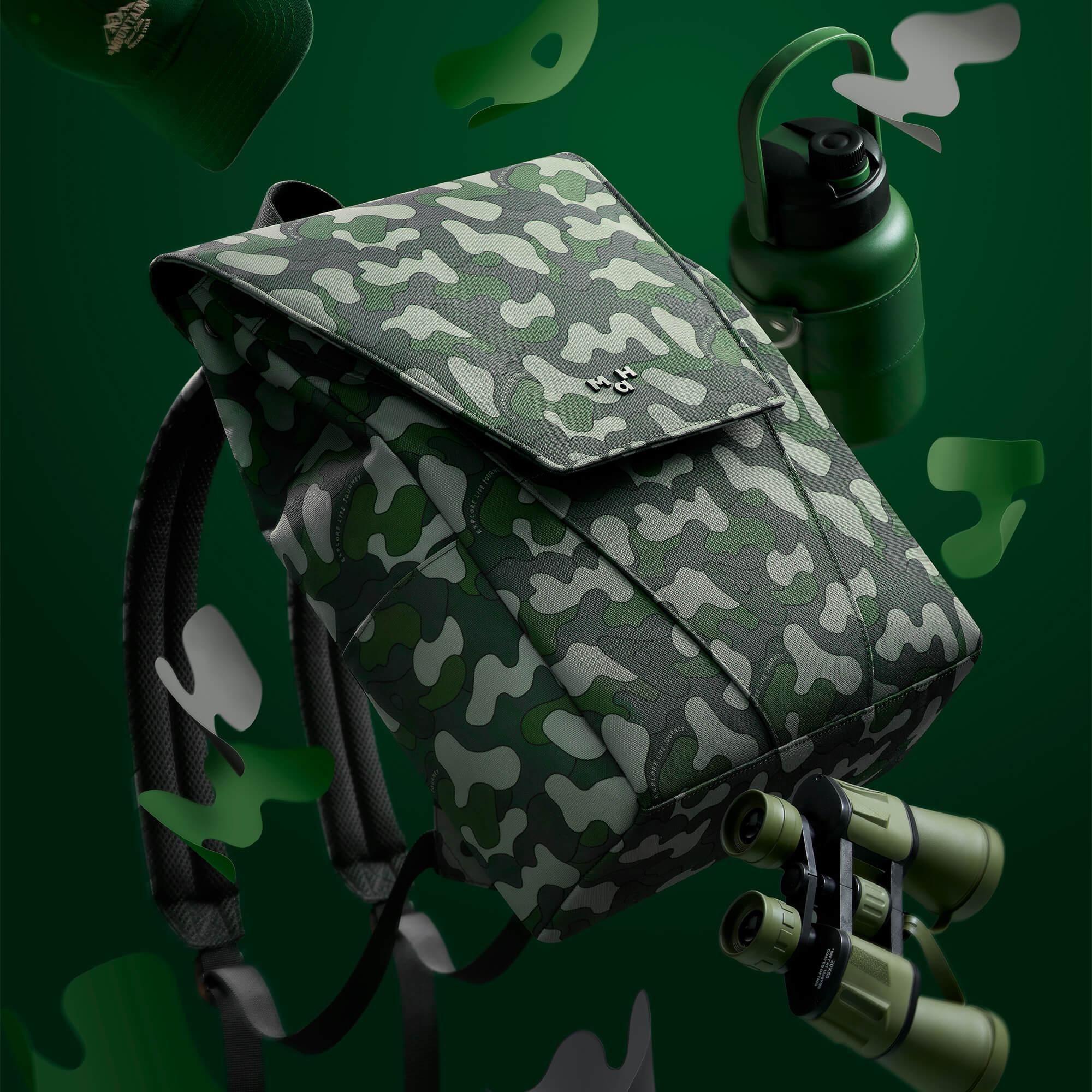 Camouflage backpack with binoculars and green water bottle, adventure gear for outdoor exploration