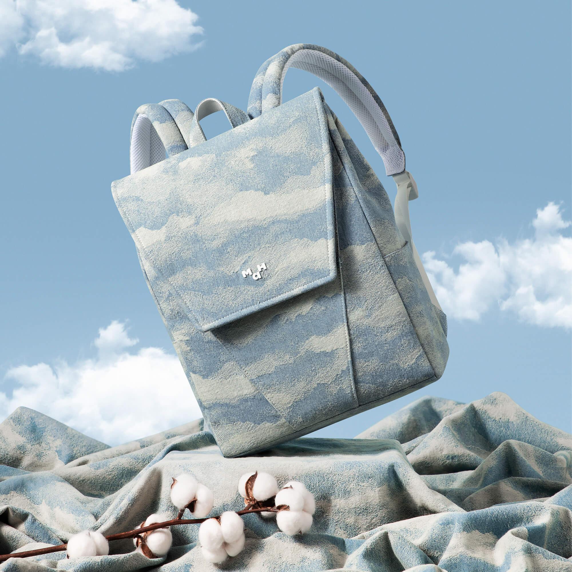 Light blue cloud-patterned backpack with cotton accents, ideal for everyday use and travel