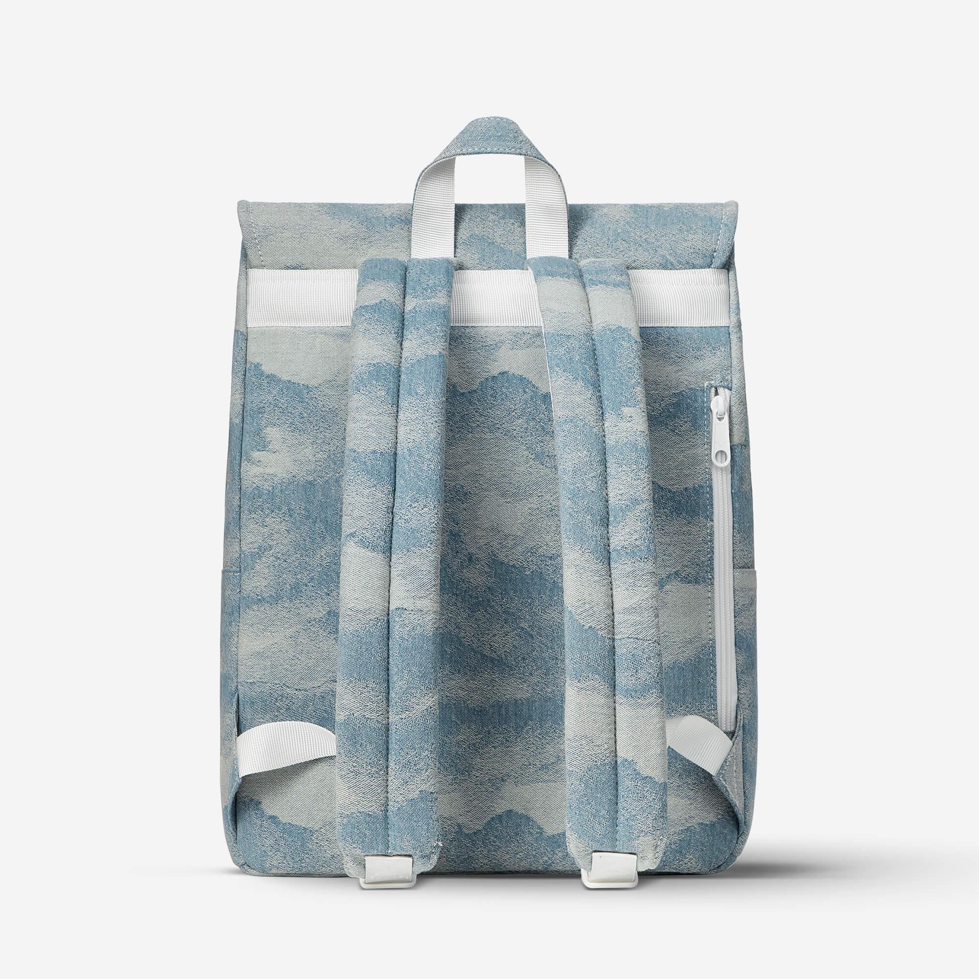 Blue and white cloud-patterned backpack with padded straps and side zipper pocket