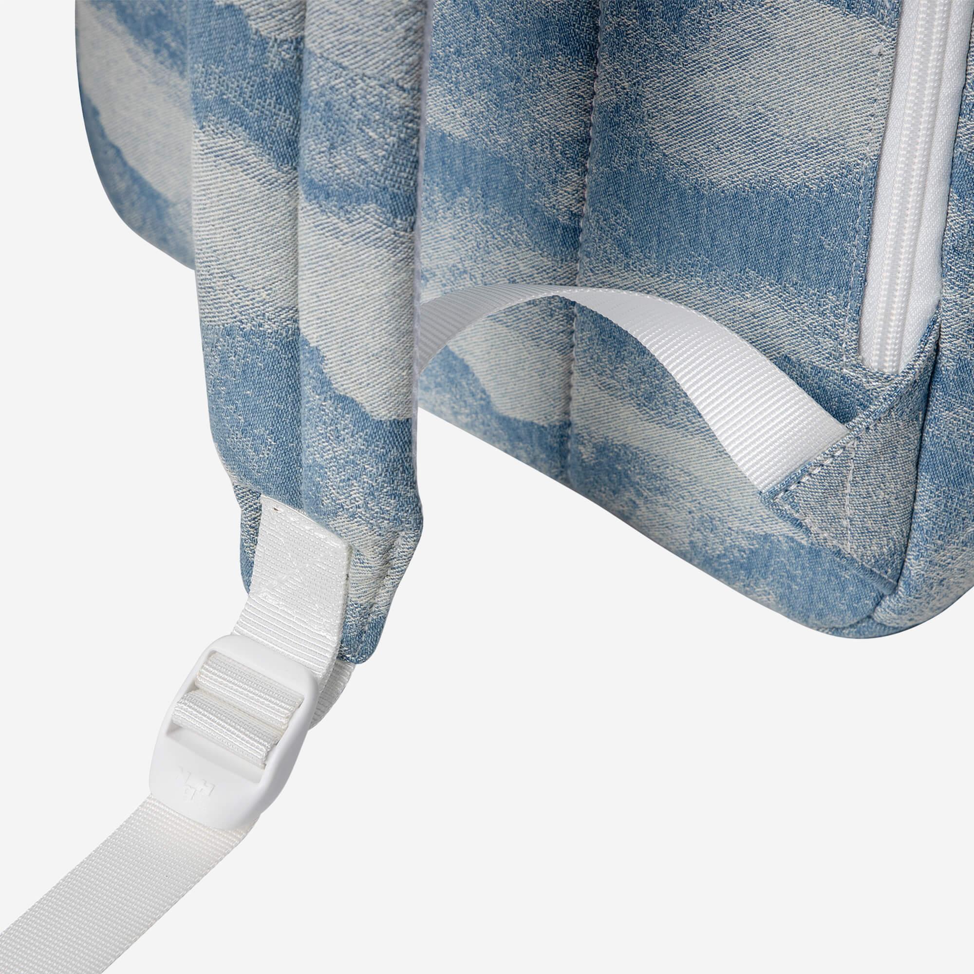 Denim backpack with white straps and adjustable buckle, stylish everyday carry bag
