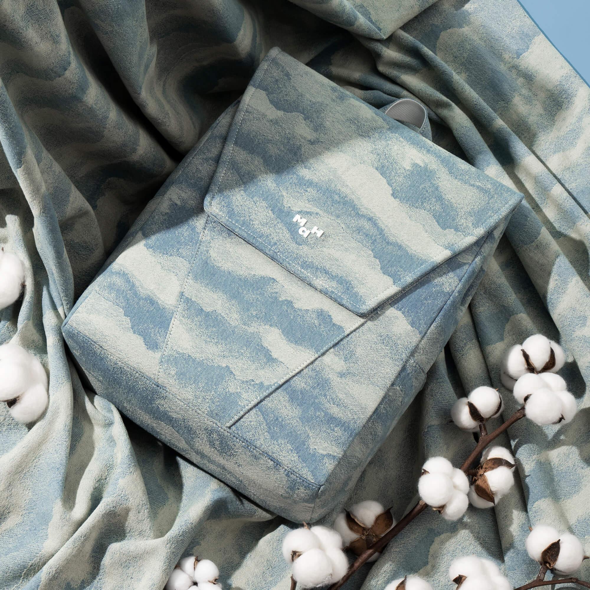 Blue cloud-patterned backpack with cotton accents, stylish and design-driven bag accessory