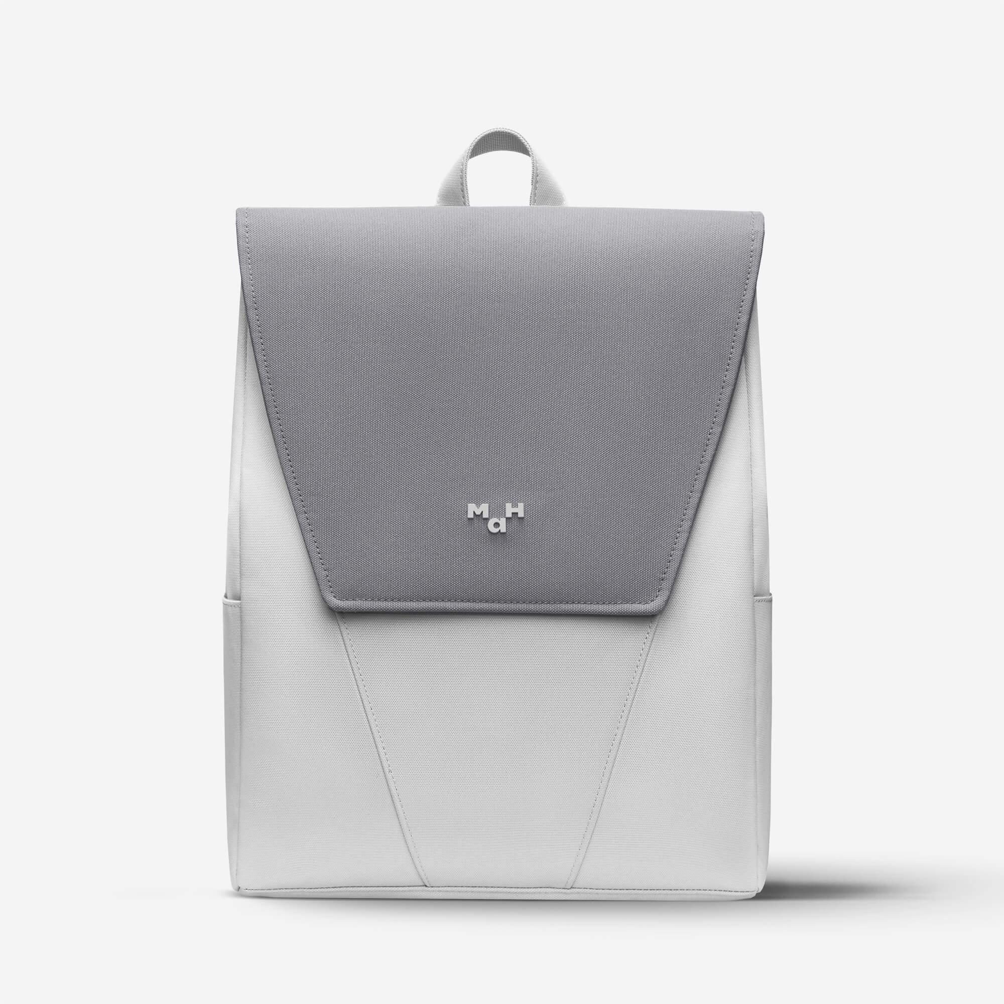 Modern gray and white backpack with minimalist design and front flap closure, ideal for daily use or travel.