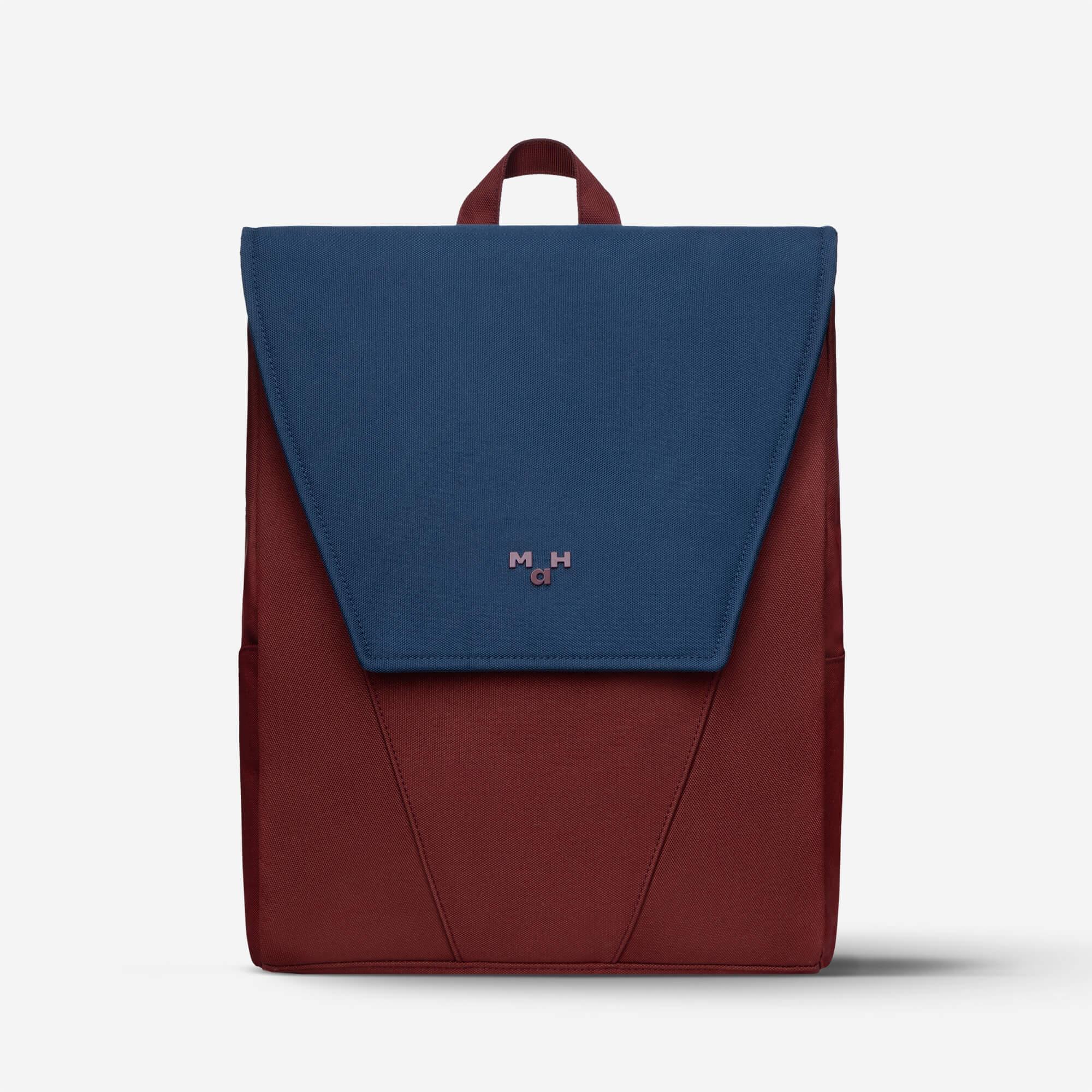 Navy and burgundy color-block backpack with minimalist design and top handle