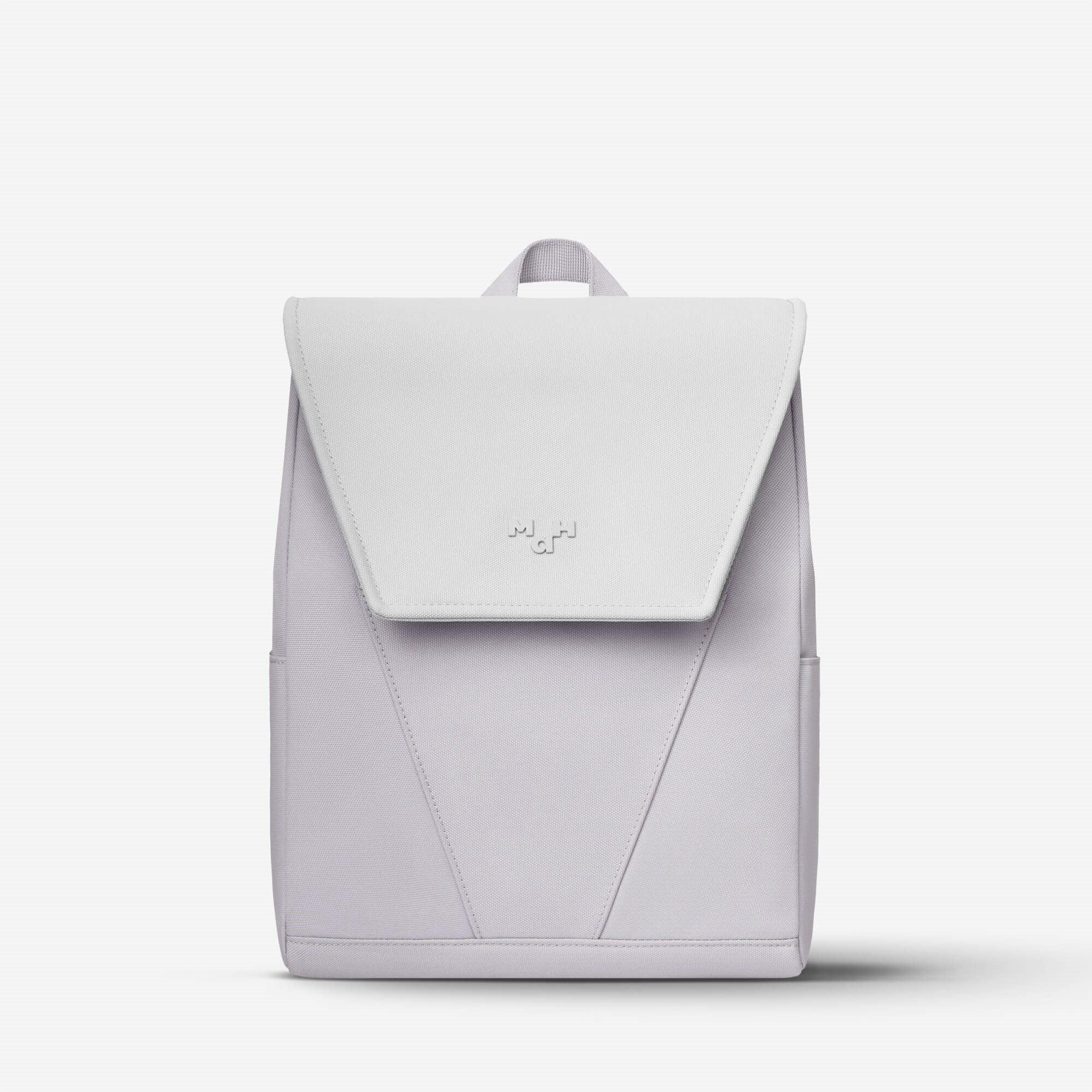 Light gray minimalist backpack with flap closure and subtle logo, ideal for everyday carry and urban style.