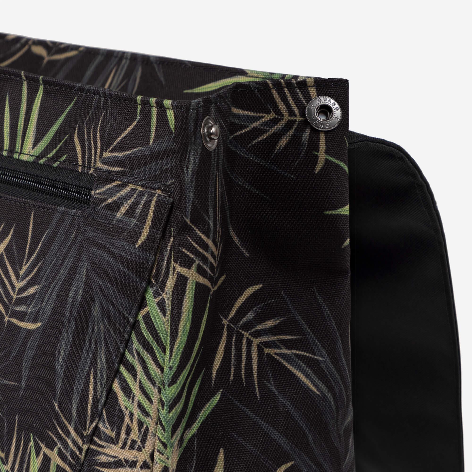 Tropical leaf patterned backpack with metal grommets and zipper detail